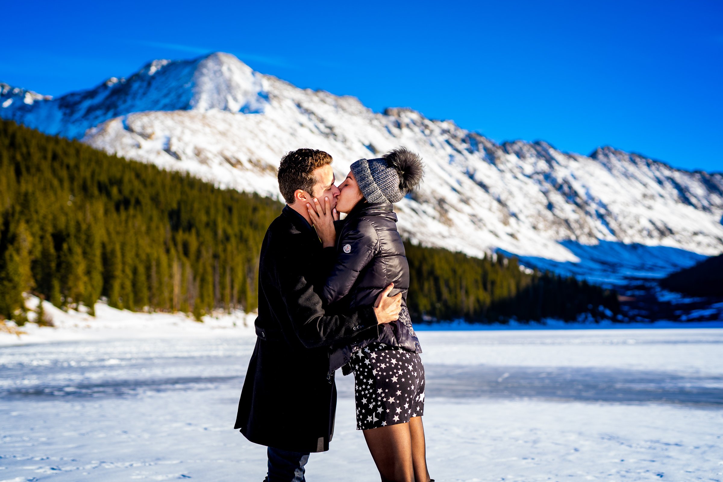 Man proposes to girlfriend while standing on a frozen lake with snowcapped mountains in the background, Engagement Session, Engagement Photos, Engagement Photos Inspiration, Engagement Photography, Engagement Photographer, Winter Engagement Photos, Proposal Photos, Proposal Photographer, Proposal Photography, Winter Proposal, Mountain Proposal, Proposal Inspiration, Summit County engagement session, Summit County engagement photos, Summit County engagement photography, Summit County engagement photographer, Summit County engagement inspiration, Colorado engagement session, Colorado engagement photos, Colorado engagement photography, Colorado engagement photographer, Colorado engagement inspiration, Clinton Gulch Engagement