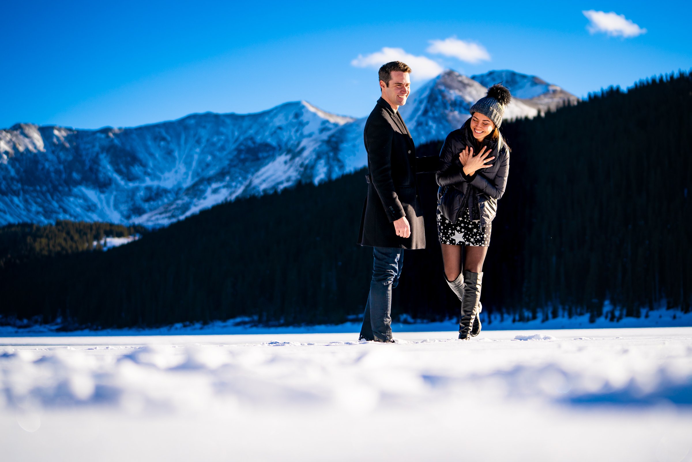 Man proposes to girlfriend while standing on a frozen lake with snowcapped mountains in the background, Engagement Session, Engagement Photos, Engagement Photos Inspiration, Engagement Photography, Engagement Photographer, Winter Engagement Photos, Proposal Photos, Proposal Photographer, Proposal Photography, Winter Proposal, Mountain Proposal, Proposal Inspiration, Summit County engagement session, Summit County engagement photos, Summit County engagement photography, Summit County engagement photographer, Summit County engagement inspiration, Colorado engagement session, Colorado engagement photos, Colorado engagement photography, Colorado engagement photographer, Colorado engagement inspiration, Clinton Gulch Engagement