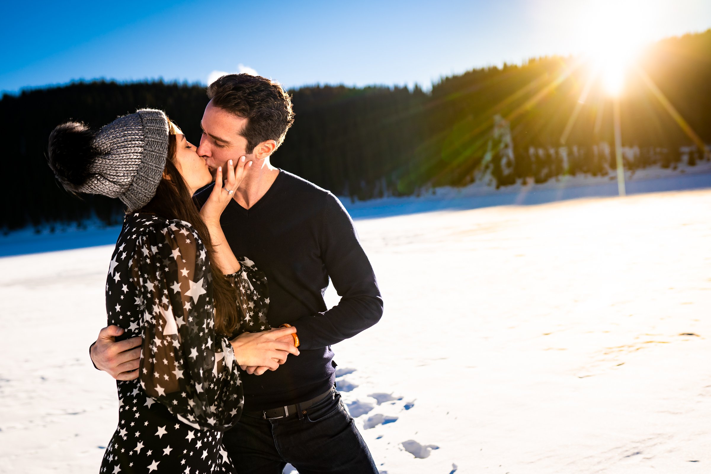 Newly engaged couple celebrate their proposal on a frozen lake with snowcapped mountains in the background, Engagement Session, Engagement Photos, Engagement Photos Inspiration, Engagement Photography, Engagement Photographer, Winter Engagement Photos, Proposal Photos, Proposal Photographer, Proposal Photography, Winter Proposal, Mountain Proposal, Proposal Inspiration, Summit County engagement session, Summit County engagement photos, Summit County engagement photography, Summit County engagement photographer, Summit County engagement inspiration, Colorado engagement session, Colorado engagement photos, Colorado engagement photography, Colorado engagement photographer, Colorado engagement inspiration, Clinton Gulch Engagement