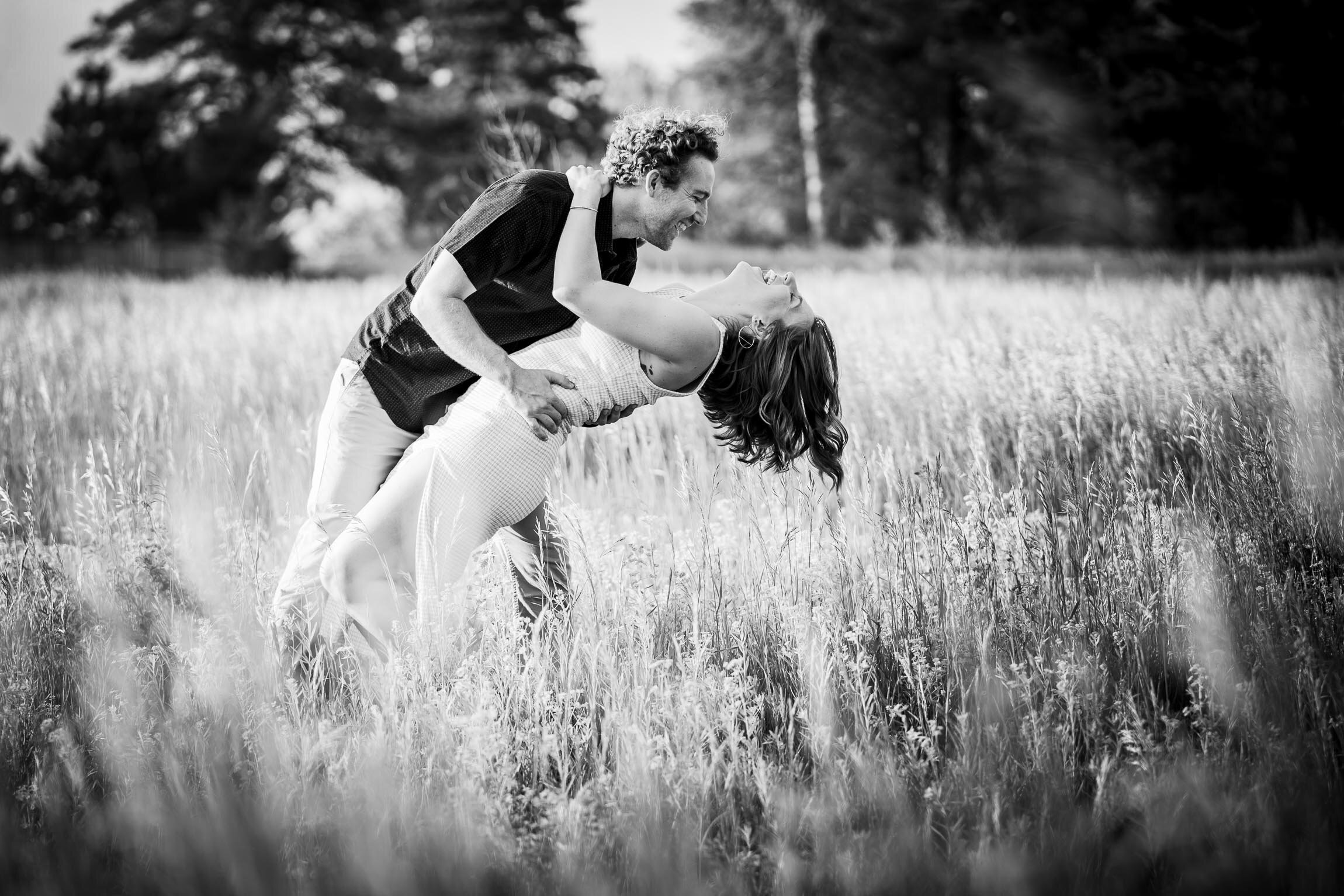 Engaged couple walks while holding hands in the tall windswept grass during golden hour, Engagement Session, Engagement Photos, Engagement Photos Inspiration, Engagement Photography, Engagement Photographer, Winter Engagement Photos, Mountain Engagement Photos, Denver engagement session, Denver engagement photos, Denver engagement photography, Denver engagement photographer, Denver engagement inspiration, Colorado engagement session, Colorado engagement photos, Colorado engagement photography, Colorado engagement photographer, Colorado engagement inspiration