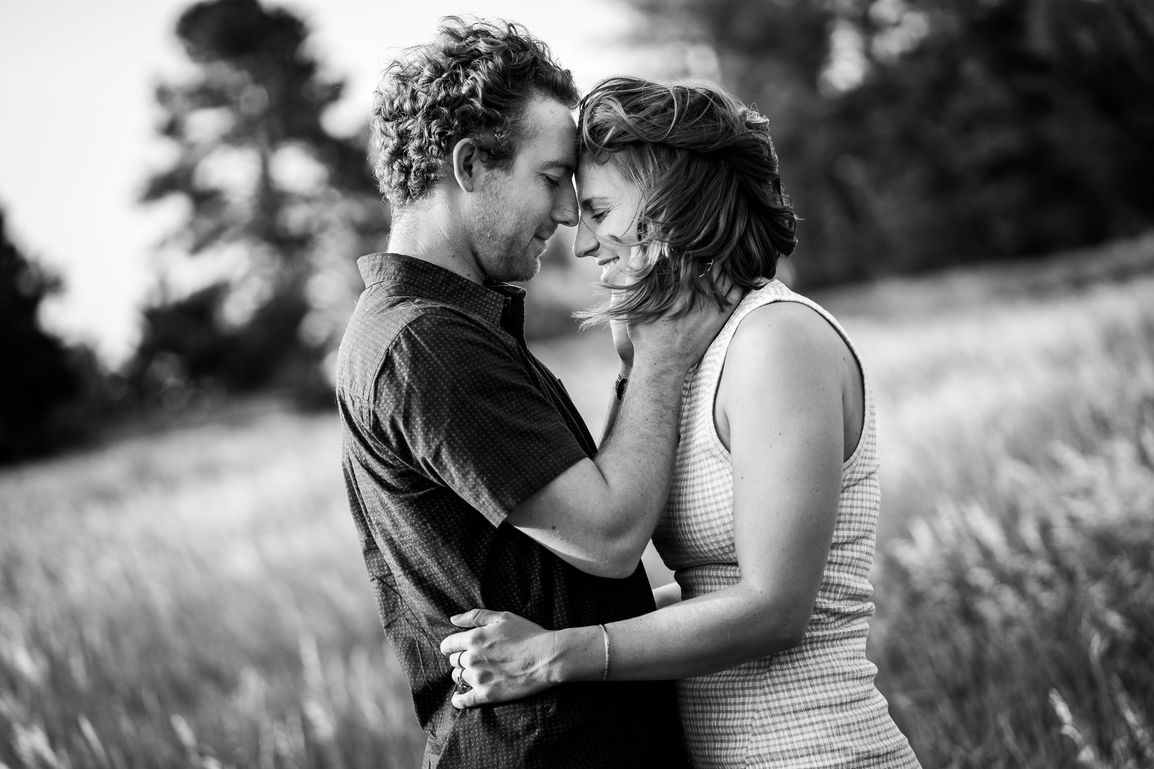 Engaged couple embraces for a portrait in tall windswept grass during golden hour, Engagement Session, Engagement Photos, Engagement Photos Inspiration, Engagement Photography, Engagement Photographer, Winter Engagement Photos, Mountain Engagement Photos, Denver engagement session, Denver engagement photos, Denver engagement photography, Denver engagement photographer, Denver engagement inspiration, Colorado engagement session, Colorado engagement photos, Colorado engagement photography, Colorado engagement photographer, Colorado engagement inspiration