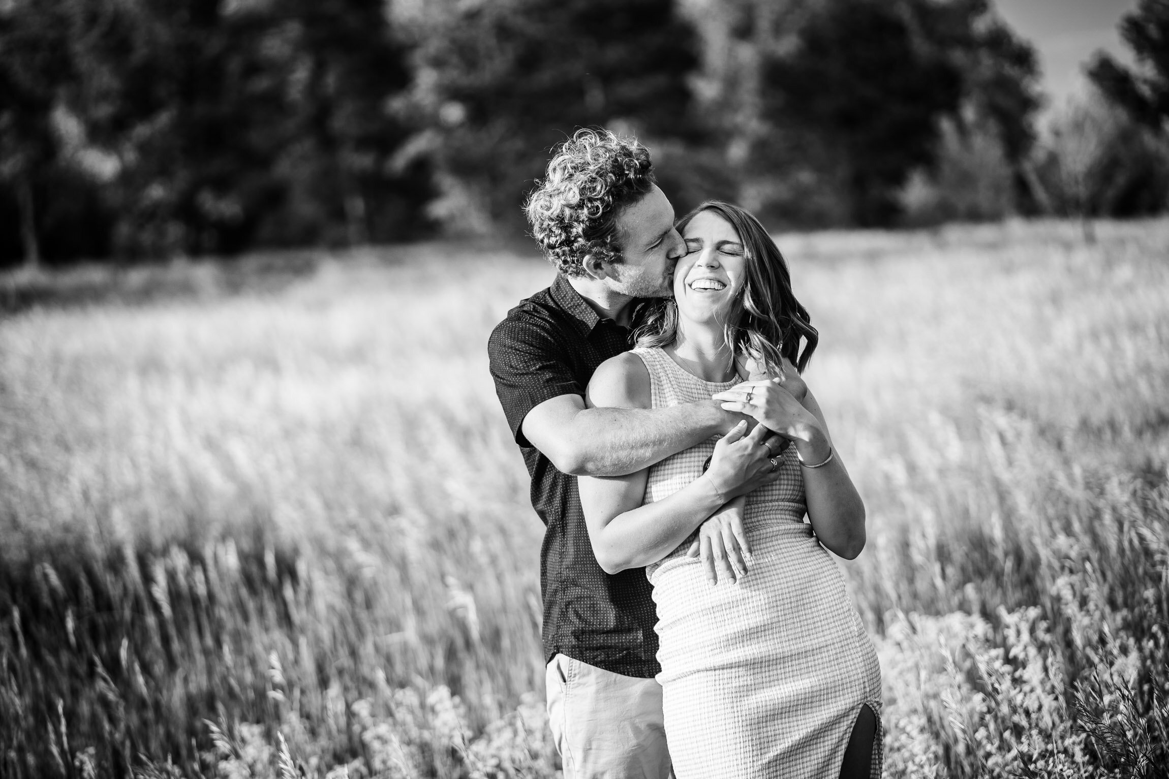 Engaged couple embraces for a portrait in tall windswept grass during golden hour, Engagement Session, Engagement Photos, Engagement Photos Inspiration, Engagement Photography, Engagement Photographer, Winter Engagement Photos, Mountain Engagement Photos, Denver engagement session, Denver engagement photos, Denver engagement photography, Denver engagement photographer, Denver engagement inspiration, Colorado engagement session, Colorado engagement photos, Colorado engagement photography, Colorado engagement photographer, Colorado engagement inspiration