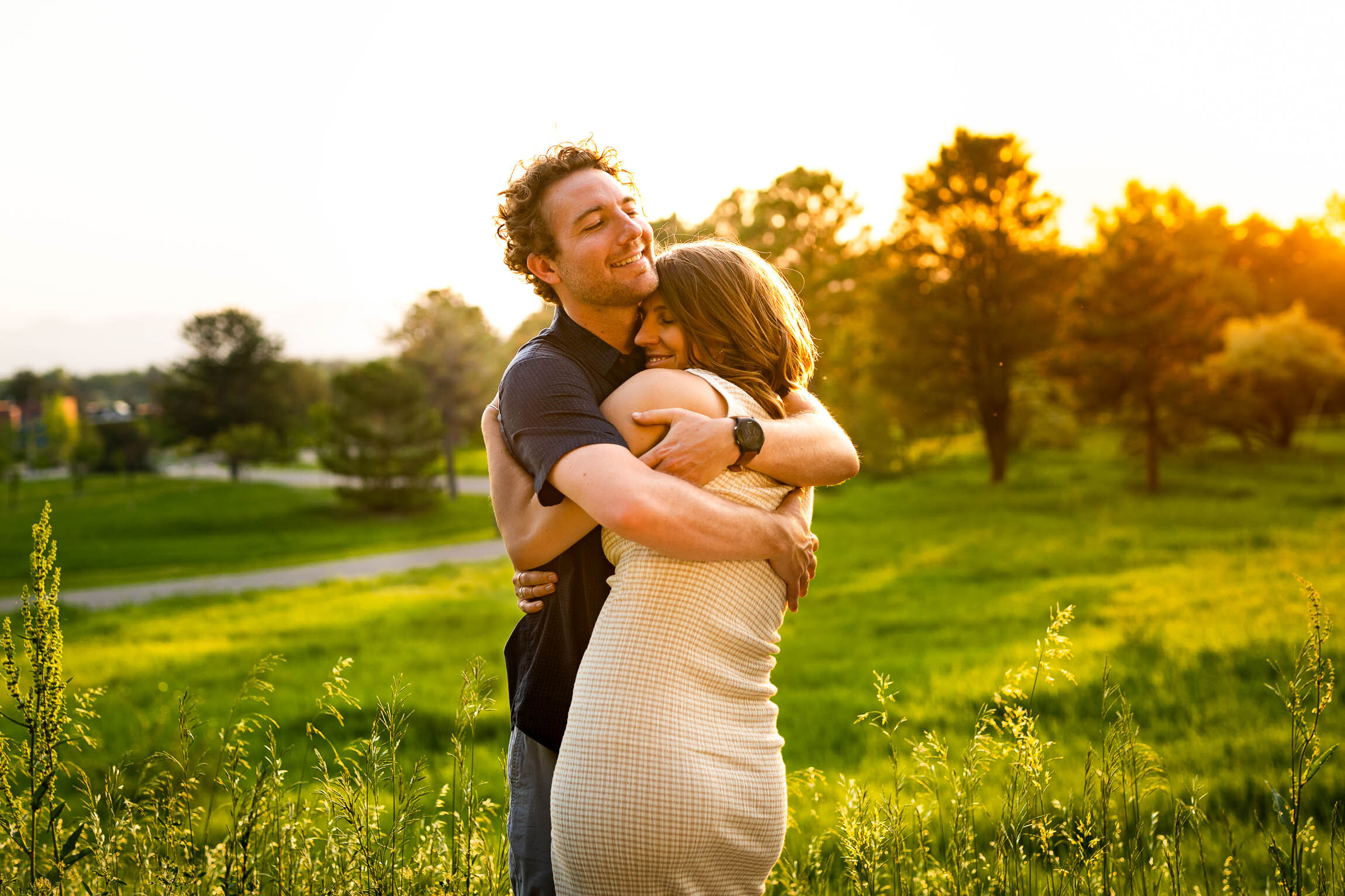 Engaged couple embraces in a field  during golden hour, Engagement Session, Engagement Photos, Engagement Photos Inspiration, Engagement Photography, Engagement Photographer, Winter Engagement Photos, Mountain Engagement Photos, Denver engagement session, Denver engagement photos, Denver engagement photography, Denver engagement photographer, Denver engagement inspiration, Colorado engagement session, Colorado engagement photos, Colorado engagement photography, Colorado engagement photographer, Colorado engagement inspiration