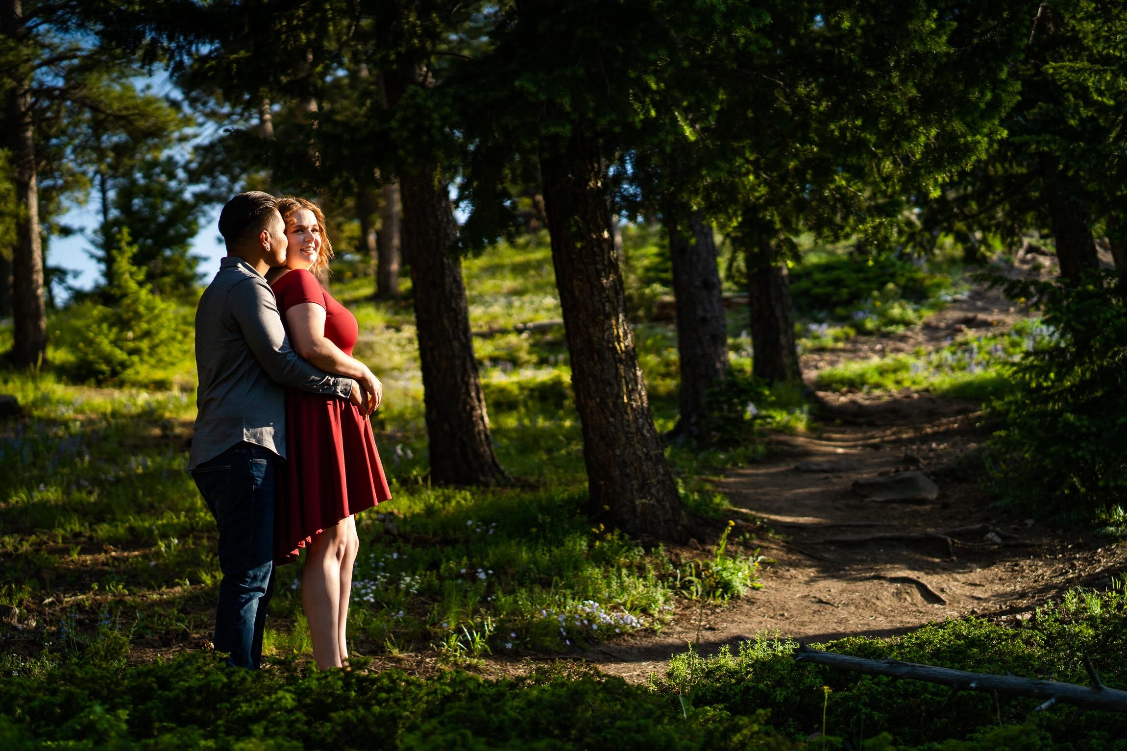 Engaged couple posing for a portrait in golden light surrounded by wildflowers in a forest, Engagement Session, Engagement Photos, Engagement Photos Inspiration, Engagement Photography, Engagement Photographer, Summer Engagement Photos, Mountain Engagement Photos, Lost Gulch Overlook engagement session, Lost Gulch Overlook engagement photos, Lost Gulch Overlook engagement photography, Lost Gulch Overlook engagement photographer, Lost Gulch Overlook  engagement inspiration, Boulder engagement session, Boulder engagement photos, Boulder engagement photography, Boulder engagement photographer, Boulder engagement inspiration, Colorado engagement session, Colorado engagement photos, Colorado engagement photography, Colorado engagement photographer, Colorado engagement inspiration