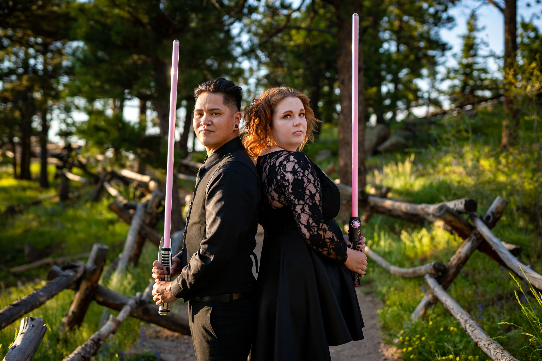 Engaged couple pose for a portrait with their light sabers in the forest during golden hour, Engagement Session, Engagement Photos, Engagement Photos Inspiration, Engagement Photography, Engagement Photographer, Summer Engagement Photos, Mountain Engagement Photos, Lost Gulch Overlook engagement session, Lost Gulch Overlook engagement photos, Lost Gulch Overlook engagement photography, Lost Gulch Overlook engagement photographer, Lost Gulch Overlook  engagement inspiration, Boulder engagement session, Boulder engagement photos, Boulder engagement photography, Boulder engagement photographer, Boulder engagement inspiration, Colorado engagement session, Colorado engagement photos, Colorado engagement photography, Colorado engagement photographer, Colorado engagement inspiration