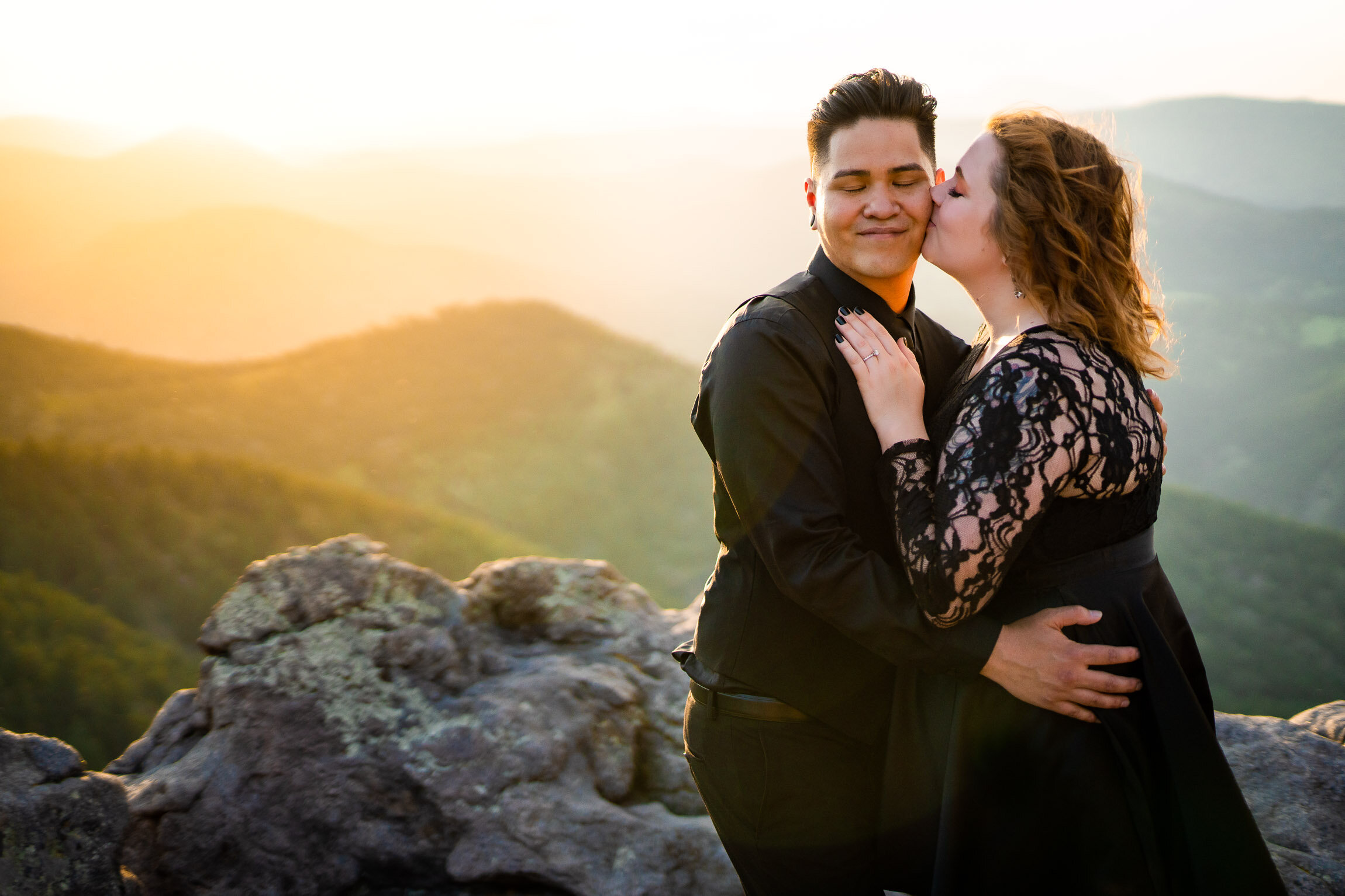 Engaged couple kisses for a portrait on a rocky ledge overlooking the mountains during sunset, Engagement Session, Sunset Engagement photos, Engagement Photos, Engagement Photos Inspiration, Engagement Photography, Engagement Photographer, Summer Engagement Photos, Mountain Engagement Photos, Lost Gulch Overlook engagement session, Lost Gulch Overlook engagement photos, Lost Gulch Overlook engagement photography, Lost Gulch Overlook engagement photographer, Lost Gulch Overlook  engagement inspiration, Boulder engagement session, Boulder engagement photos, Boulder engagement photography, Boulder engagement photographer, Boulder engagement inspiration, Colorado engagement session, Colorado engagement photos, Colorado engagement photography, Colorado engagement photographer, Colorado engagement inspiration