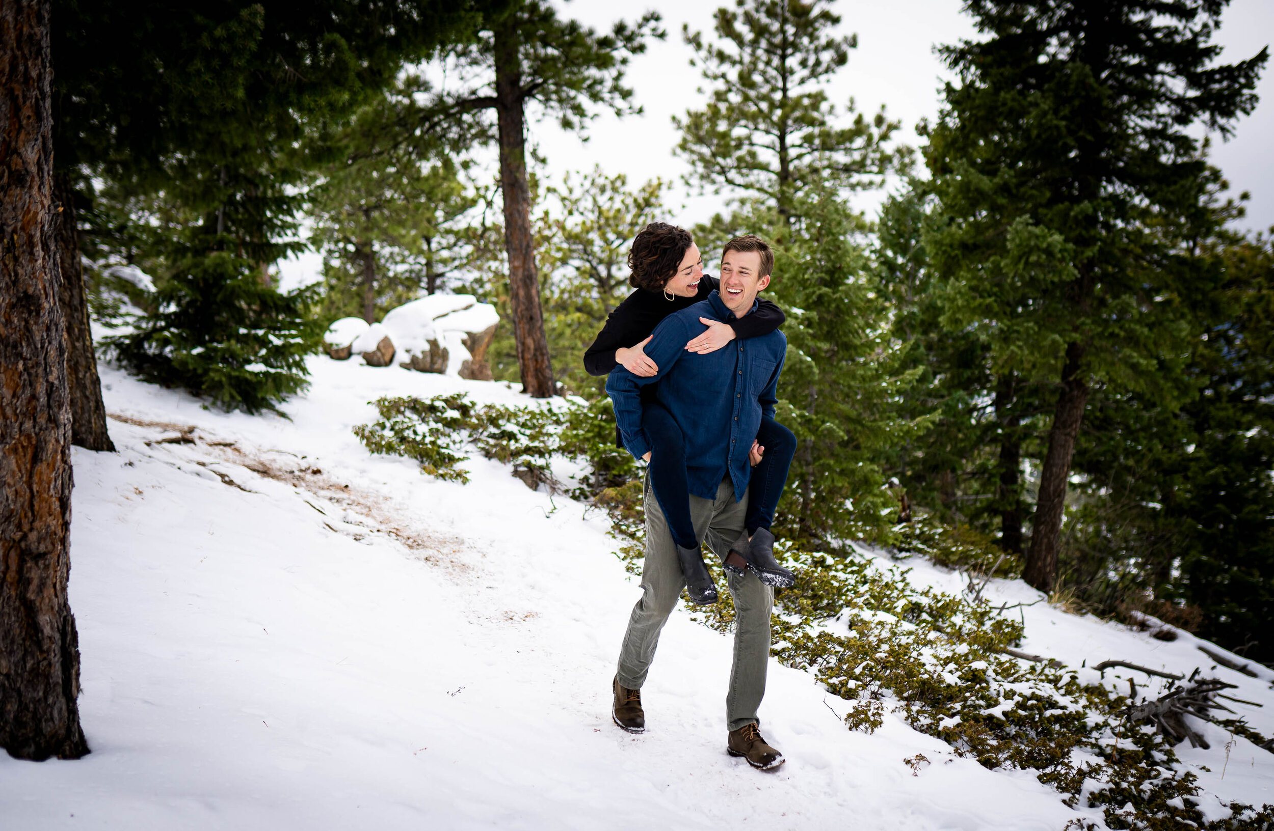 Engaged couple walks while holding hands in the snow in a dense evergreen mountain forest, Engagement Session, Engagement Photos, Engagement Photos Inspiration, Engagement Photography, Engagement Photographer, Winter Engagement Photos, Mountain Engagement Photos, Lost Gulch Overlook engagement session, Lost Gulch Overlook engagement photos, Lost Gulch Overlook engagement photography, Lost Gulch Overlook engagement photographer, Lost Gulch Overlook  engagement inspiration, Boulder engagement session, Boulder engagement photos, Boulder engagement photography, Boulder engagement photographer, Boulder engagement inspiration, Colorado engagement session, Colorado engagement photos, Colorado engagement photography, Colorado engagement photographer, Colorado engagement inspiration