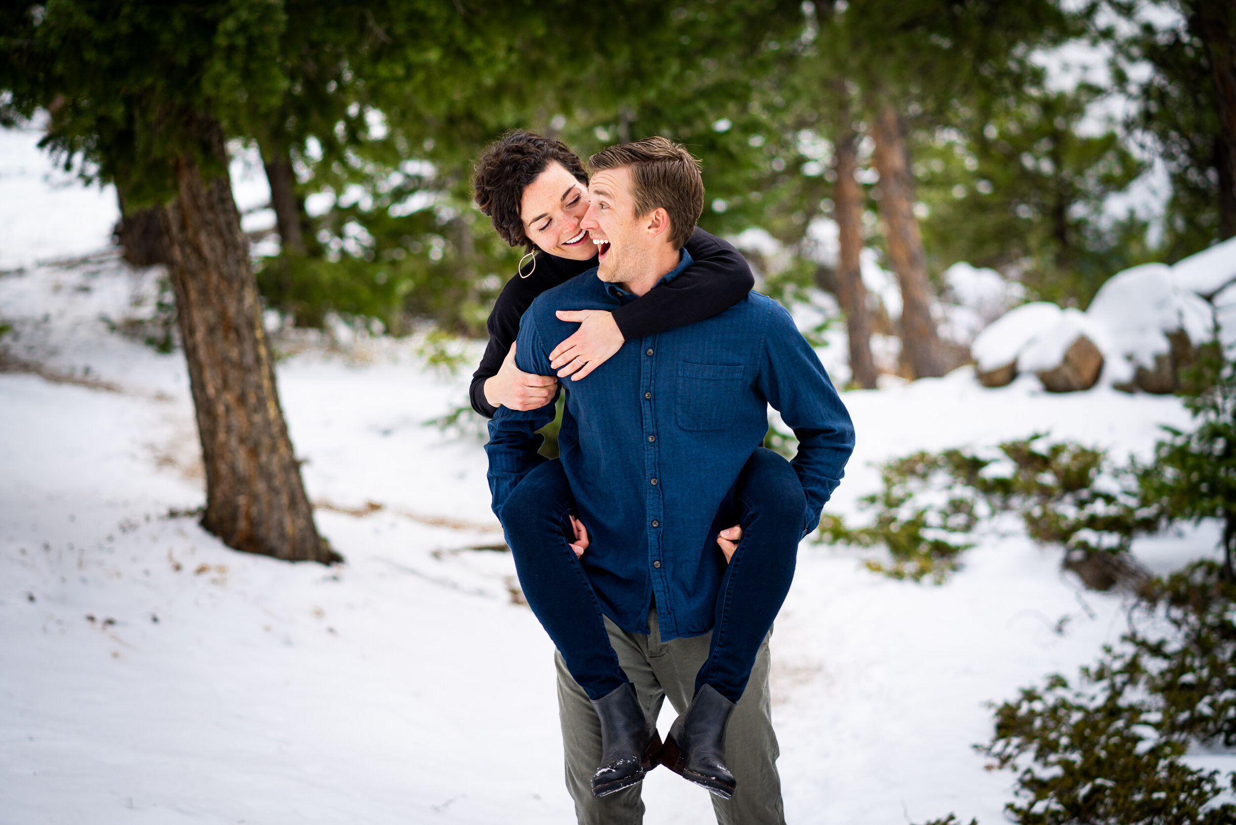 Engaged couple walks while holding hands in the snow in a dense evergreen mountain forest, Engagement Session, Engagement Photos, Engagement Photos Inspiration, Engagement Photography, Engagement Photographer, Winter Engagement Photos, Mountain Engagement Photos, Lost Gulch Overlook engagement session, Lost Gulch Overlook engagement photos, Lost Gulch Overlook engagement photography, Lost Gulch Overlook engagement photographer, Lost Gulch Overlook  engagement inspiration, Boulder engagement session, Boulder engagement photos, Boulder engagement photography, Boulder engagement photographer, Boulder engagement inspiration, Colorado engagement session, Colorado engagement photos, Colorado engagement photography, Colorado engagement photographer, Colorado engagement inspiration