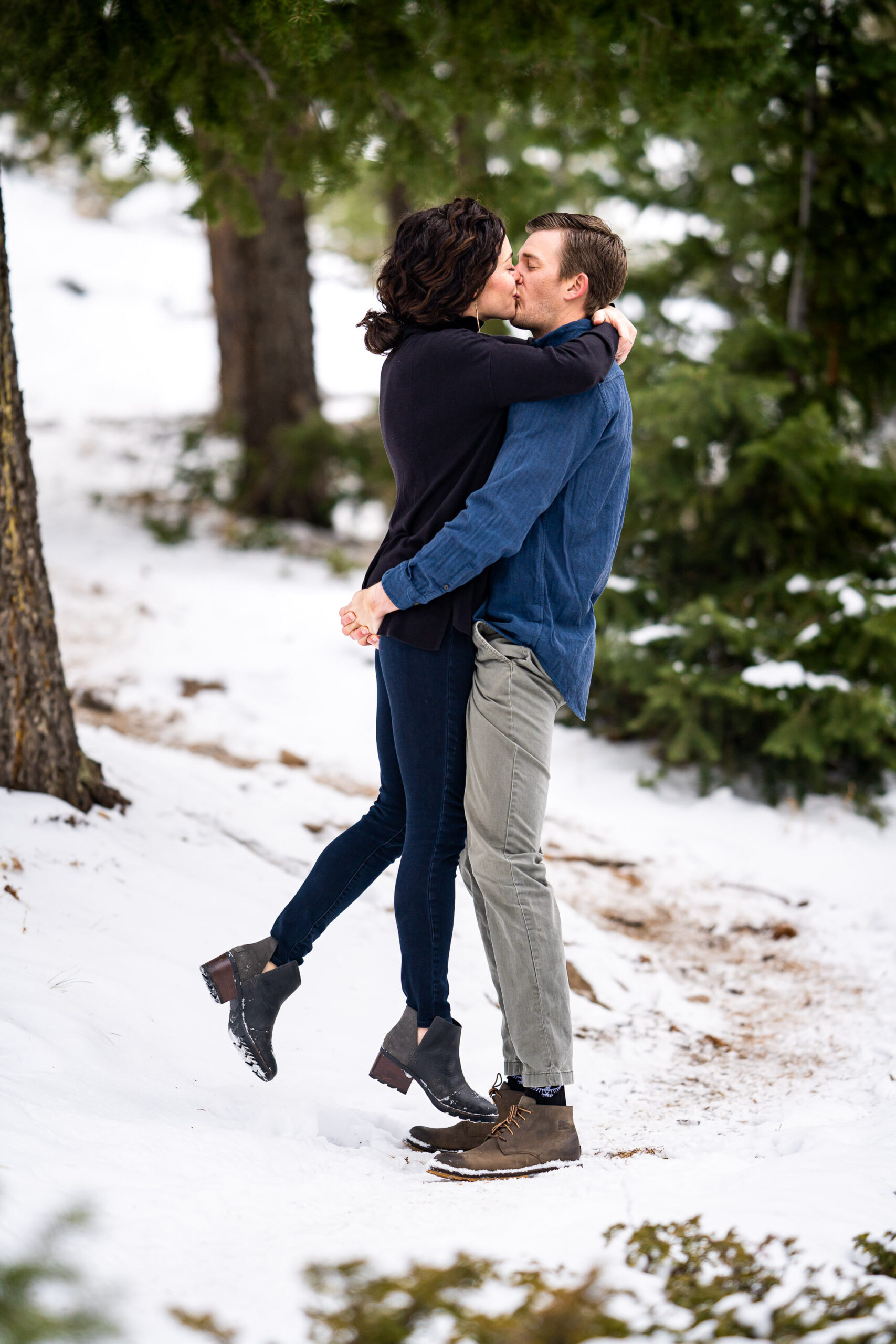Engaged couple kisses in the snow in a dense evergreen mountain forest, Engagement Session, Engagement Photos, Engagement Photos Inspiration, Engagement Photography, Engagement Photographer, Winter Engagement Photos, Mountain Engagement Photos, Lost Gulch Overlook engagement session, Lost Gulch Overlook engagement photos, Lost Gulch Overlook engagement photography, Lost Gulch Overlook engagement photographer, Lost Gulch Overlook  engagement inspiration, Boulder engagement session, Boulder engagement photos, Boulder engagement photography, Boulder engagement photographer, Boulder engagement inspiration, Colorado engagement session, Colorado engagement photos, Colorado engagement photography, Colorado engagement photographer, Colorado engagement inspiration
