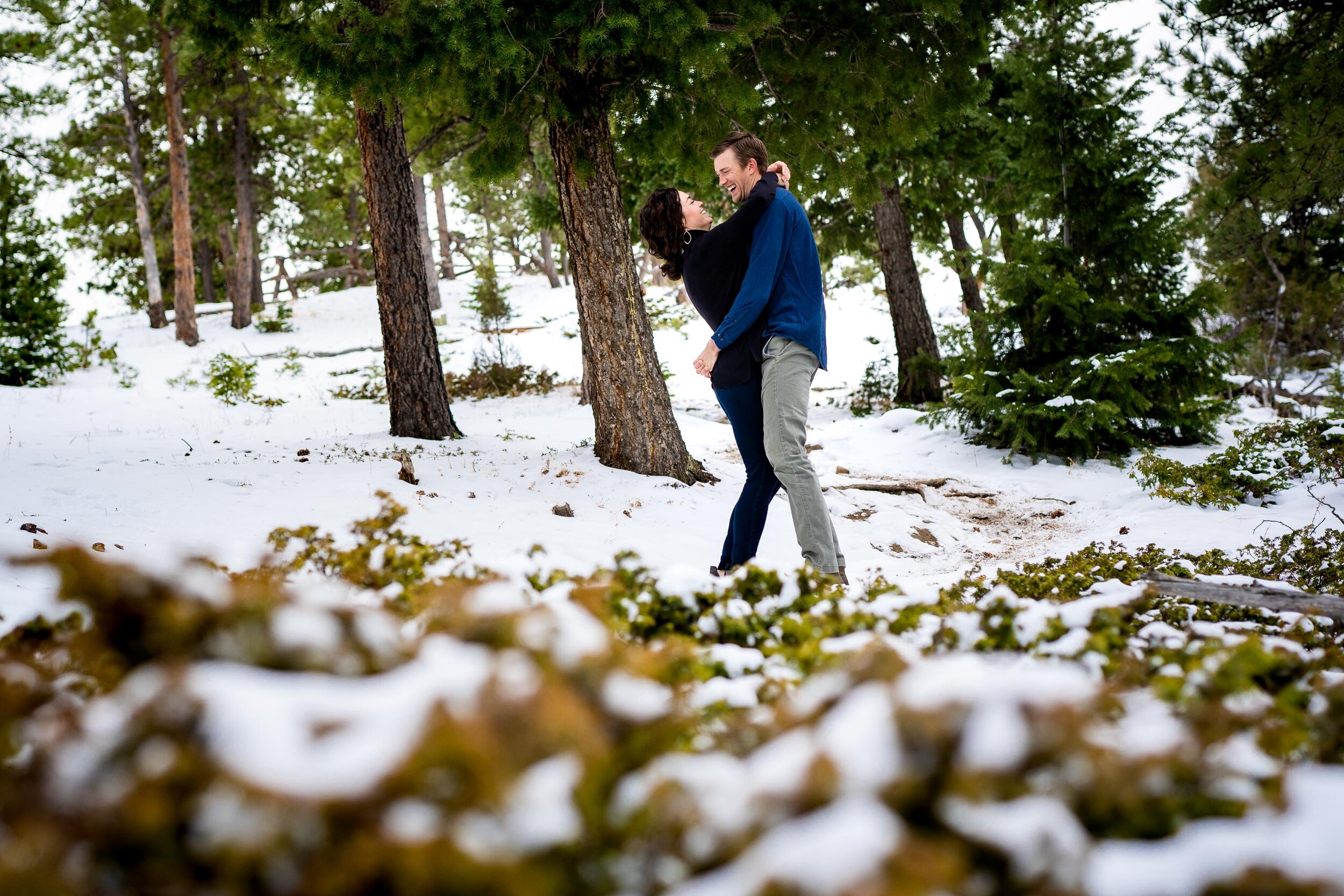 Engaged couple embraces in the snow in a dense evergreen mountain forest, Engagement Session, Engagement Photos, Engagement Photos Inspiration, Engagement Photography, Engagement Photographer, Winter Engagement Photos, Mountain Engagement Photos, Lost Gulch Overlook engagement session, Lost Gulch Overlook engagement photos, Lost Gulch Overlook engagement photography, Lost Gulch Overlook engagement photographer, Lost Gulch Overlook  engagement inspiration, Boulder engagement session, Boulder engagement photos, Boulder engagement photography, Boulder engagement photographer, Boulder engagement inspiration, Colorado engagement session, Colorado engagement photos, Colorado engagement photography, Colorado engagement photographer, Colorado engagement inspiration