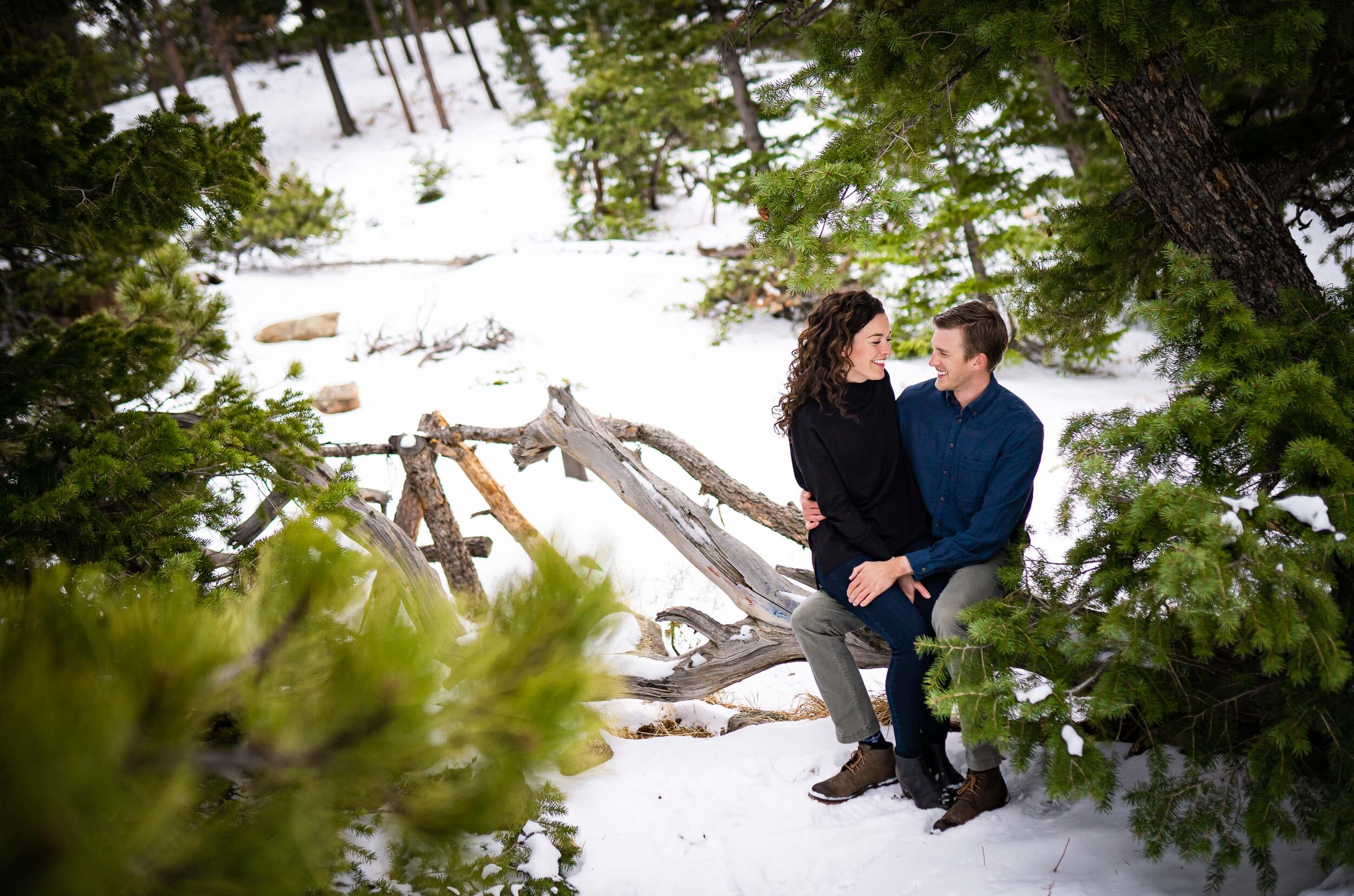 Engaged couple embraces in the snow in a dense evergreen mountain forest, Engagement Session, Engagement Photos, Engagement Photos Inspiration, Engagement Photography, Engagement Photographer, Winter Engagement Photos, Mountain Engagement Photos, Lost Gulch Overlook engagement session, Lost Gulch Overlook engagement photos, Lost Gulch Overlook engagement photography, Lost Gulch Overlook engagement photographer, Lost Gulch Overlook  engagement inspiration, Boulder engagement session, Boulder engagement photos, Boulder engagement photography, Boulder engagement photographer, Boulder engagement inspiration, Colorado engagement session, Colorado engagement photos, Colorado engagement photography, Colorado engagement photographer, Colorado engagement inspiration