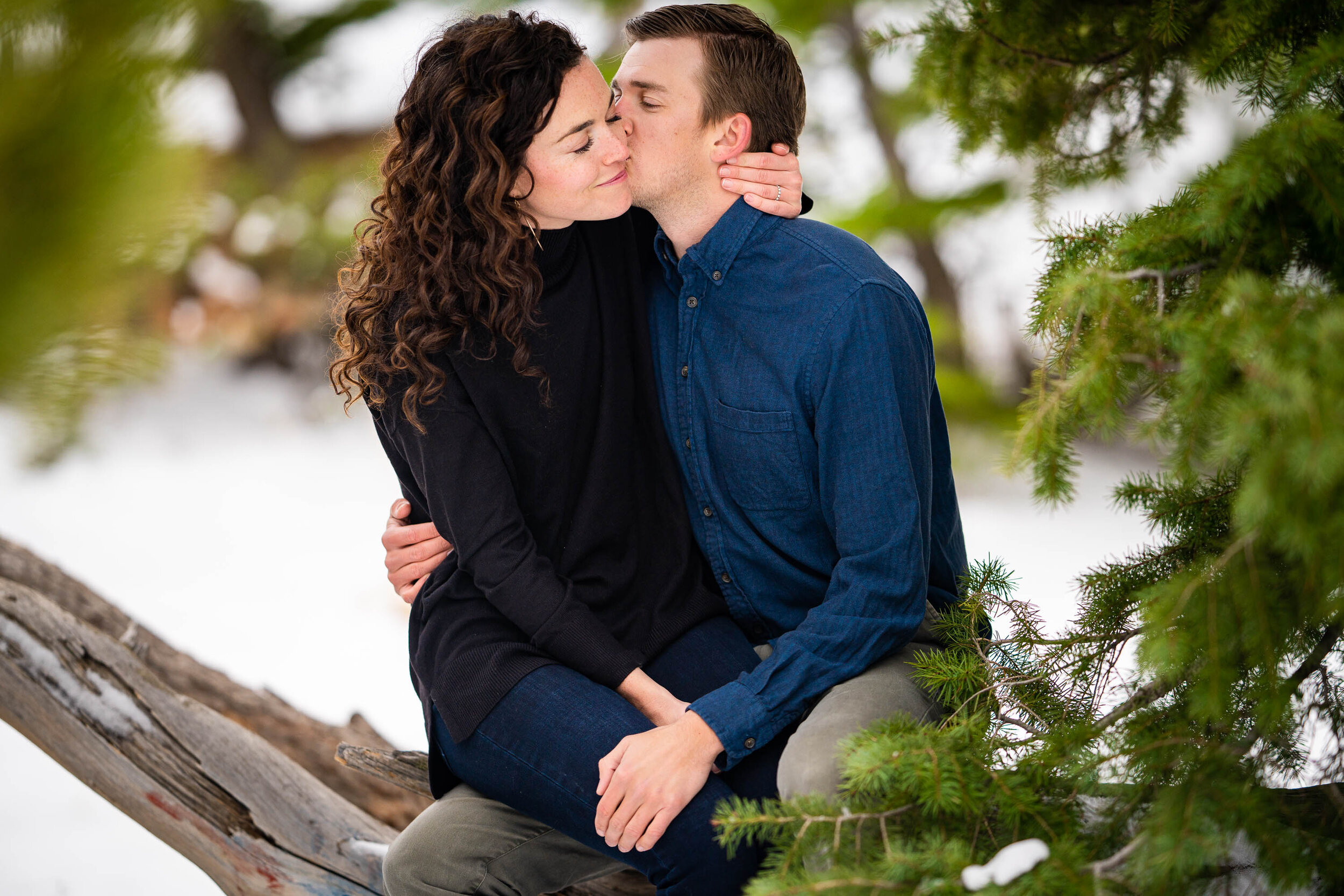 Engaged couple embraces in the snow in a dense evergreen mountain forest, Engagement Session, Engagement Photos, Engagement Photos Inspiration, Engagement Photography, Engagement Photographer, Winter Engagement Photos, Mountain Engagement Photos, Lost Gulch Overlook engagement session, Lost Gulch Overlook engagement photos, Lost Gulch Overlook engagement photography, Lost Gulch Overlook engagement photographer, Lost Gulch Overlook  engagement inspiration, Boulder engagement session, Boulder engagement photos, Boulder engagement photography, Boulder engagement photographer, Boulder engagement inspiration, Colorado engagement session, Colorado engagement photos, Colorado engagement photography, Colorado engagement photographer, Colorado engagement inspiration