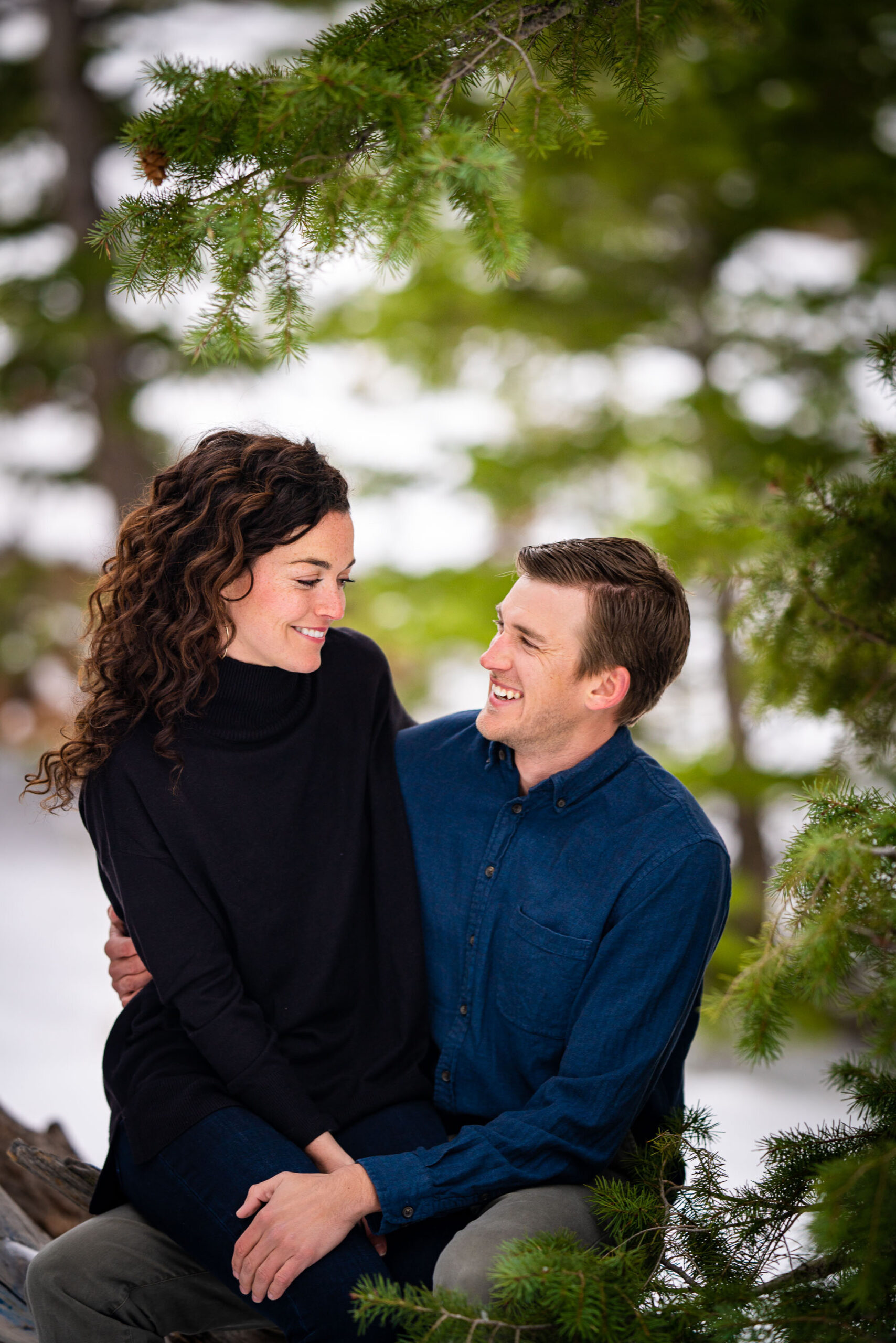 Engaged couple embraces in the snow in a dense evergreen mountain forest, Engagement Session, Engagement Photos, Engagement Photos Inspiration, Engagement Photography, Engagement Photographer, Winter Engagement Photos, Mountain Engagement Photos, Lost Gulch Overlook engagement session, Lost Gulch Overlook engagement photos, Lost Gulch Overlook engagement photography, Lost Gulch Overlook engagement photographer, Lost Gulch Overlook  engagement inspiration, Boulder engagement session, Boulder engagement photos, Boulder engagement photography, Boulder engagement photographer, Boulder engagement inspiration, Colorado engagement session, Colorado engagement photos, Colorado engagement photography, Colorado engagement photographer, Colorado engagement inspiration
