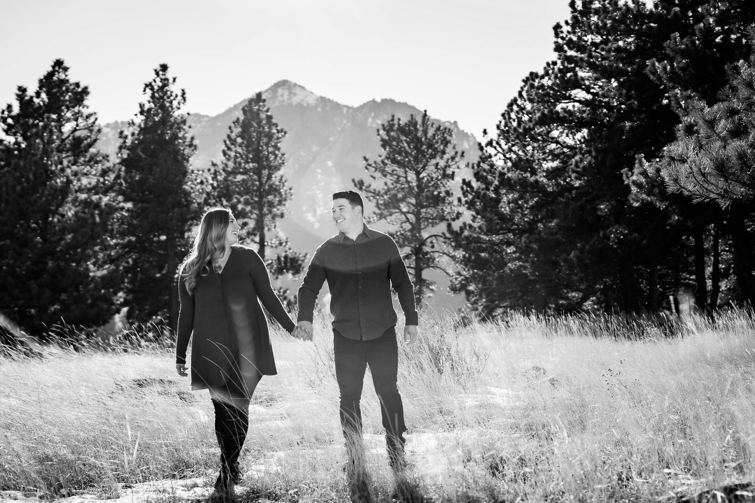 Engaged couple walks while holding hands with mountains in the background, Mountain Engagement Photos, Engagement Session, Engagement Photos, Engagement Photos Inspiration, Engagement Photography, Engagement Photographer, Engagement Portraits, Winter Engagement Photos, Snow Engagement Photos, Boulder engagement session, Boulder engagement photos, Boulder engagement photography, Boulder engagement photographer, Boulder engagement inspiration, NCAR Trail engagement session, NCAR Trail engagement photos, NCAR Trail engagement photography, NCAR Trail engagement photographer, NCAR Trail engagement inspiration, Colorado engagement session, Colorado engagement photos, Colorado engagement photography, Colorado engagement photographer, Colorado engagement inspiration