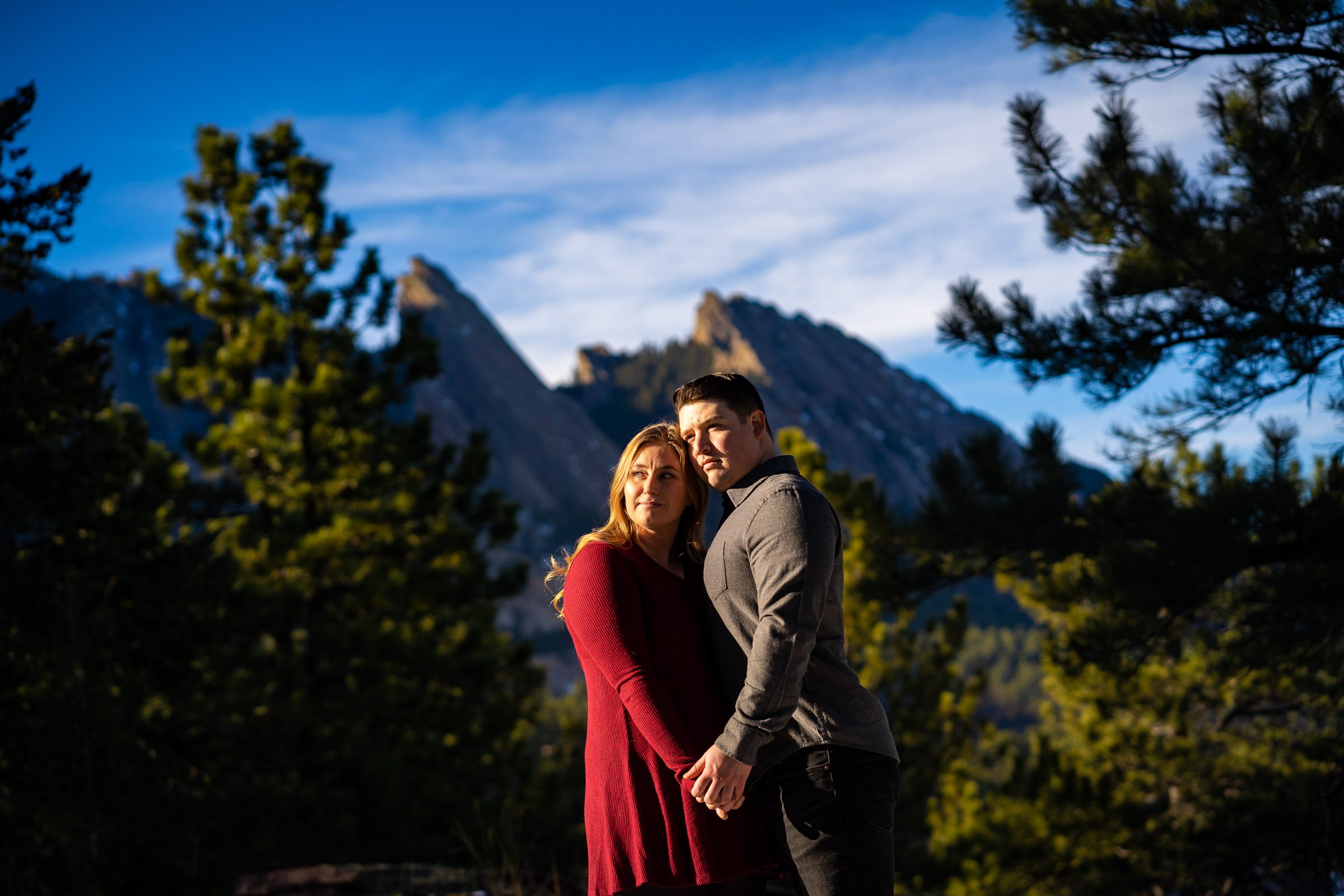 Engaged couple poses for portraits with the flatirons mountains in the background, Mountain Engagement Photos, Engagement Session, Engagement Photos, Engagement Photos Inspiration, Engagement Photography, Engagement Photographer, Engagement Portraits, Winter Engagement Photos, Snow Engagement Photos, Boulder engagement session, Boulder engagement photos, Boulder engagement photography, Boulder engagement photographer, Boulder engagement inspiration, NCAR Trail engagement session, NCAR Trail engagement photos, NCAR Trail engagement photography, NCAR Trail engagement photographer, NCAR Trail engagement inspiration, Colorado engagement session, Colorado engagement photos, Colorado engagement photography, Colorado engagement photographer, Colorado engagement inspiration