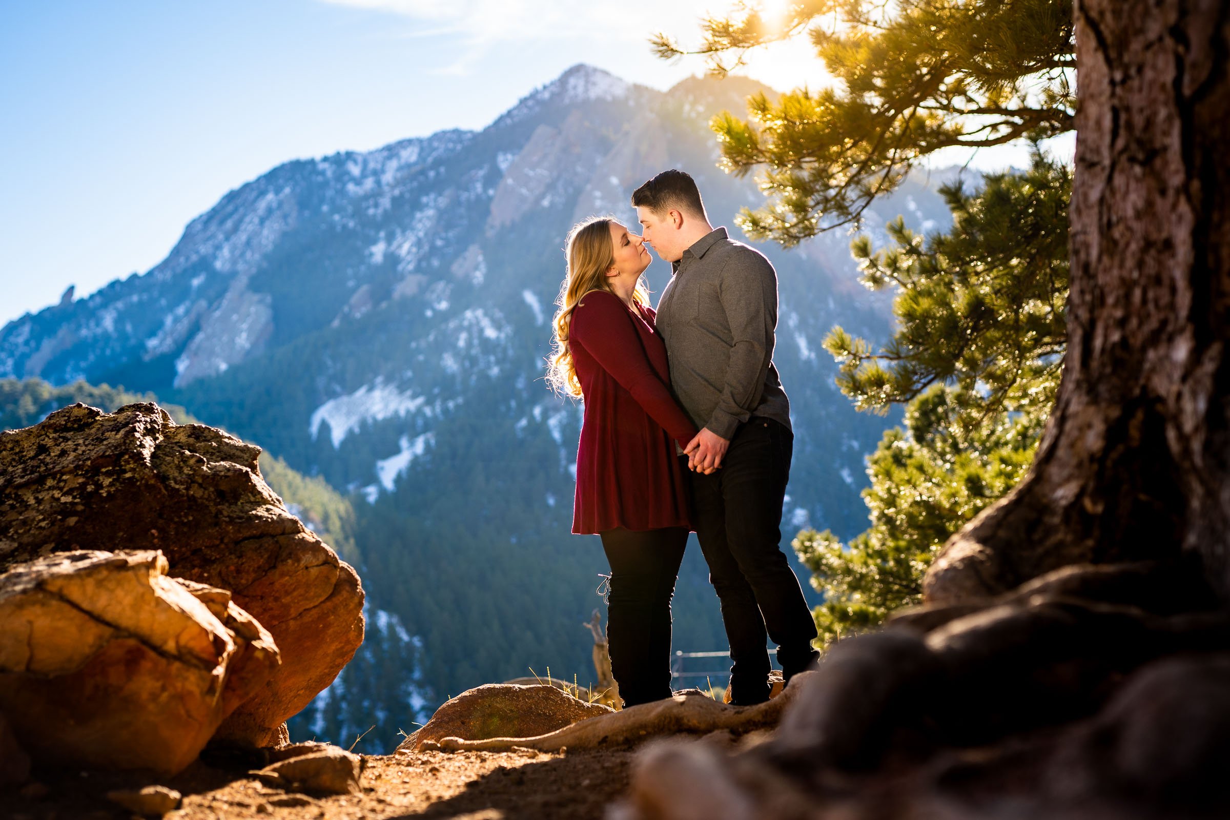 Couple poses for portraits during golden hour with mountains in the background, Mountain Engagement Photos, Engagement Session, Engagement Photos, Engagement Photos Inspiration, Engagement Photography, Engagement Photographer, Engagement Portraits, Winter Engagement Photos, Snow Engagement Photos, Boulder engagement session, Boulder engagement photos, Boulder engagement photography, Boulder engagement photographer, Boulder engagement inspiration, NCAR Trail engagement session, NCAR Trail engagement photos, NCAR Trail engagement photography, NCAR Trail engagement photographer, NCAR Trail engagement inspiration, Colorado engagement session, Colorado engagement photos, Colorado engagement photography, Colorado engagement photographer, Colorado engagement inspiration