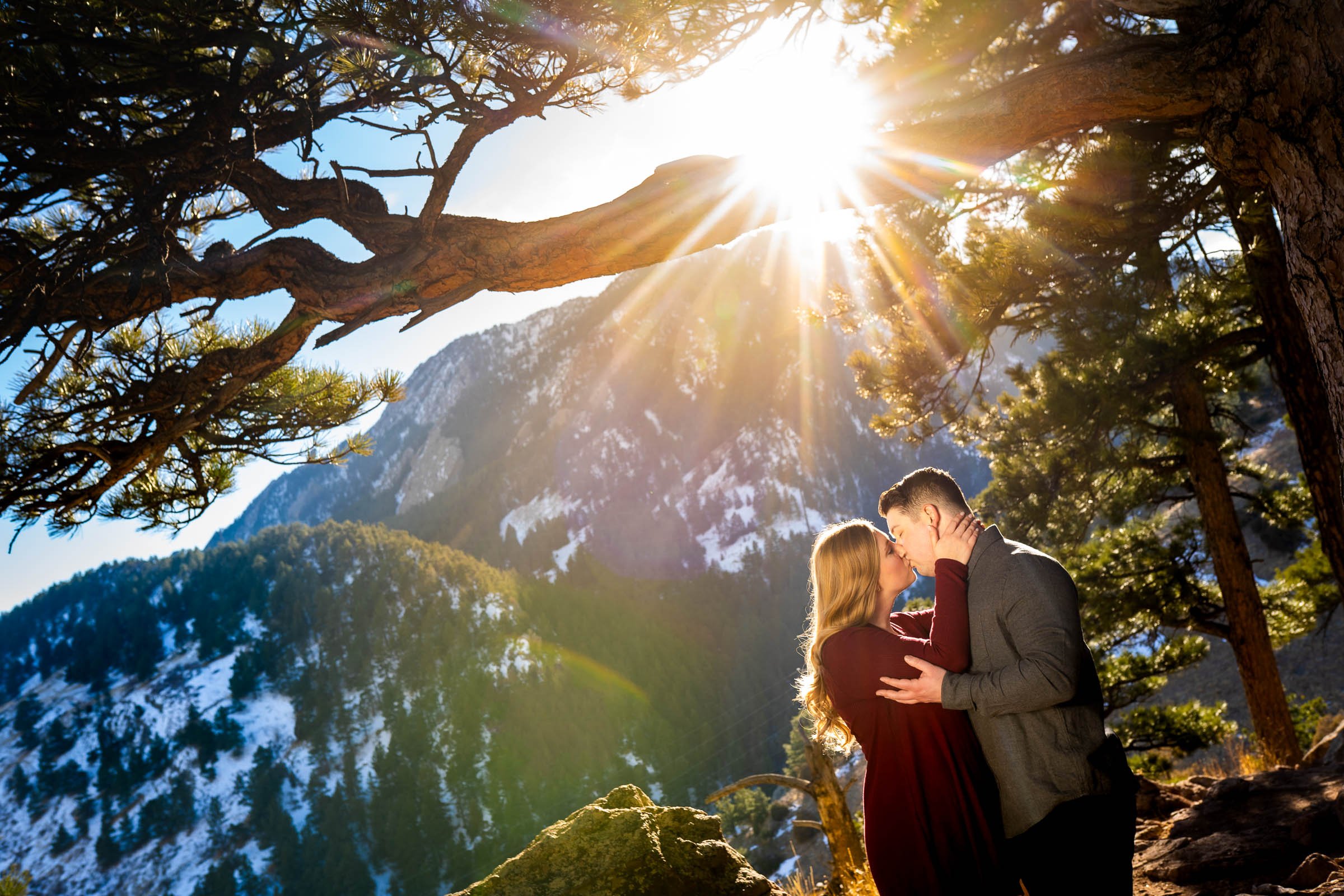 Couple poses for portraits during golden hour with snowcapped mountains in the background, Mountain Engagement Photos, Engagement Session, Engagement Photos, Engagement Photos Inspiration, Engagement Photography, Engagement Photographer, Engagement Portraits, Winter Engagement Photos, Snow Engagement Photos, Boulder engagement session, Boulder engagement photos, Boulder engagement photography, Boulder engagement photographer, Boulder engagement inspiration, NCAR Trail engagement session, NCAR Trail engagement photos, NCAR Trail engagement photography, NCAR Trail engagement photographer, NCAR Trail engagement inspiration, Colorado engagement session, Colorado engagement photos, Colorado engagement photography, Colorado engagement photographer, Colorado engagement inspiration