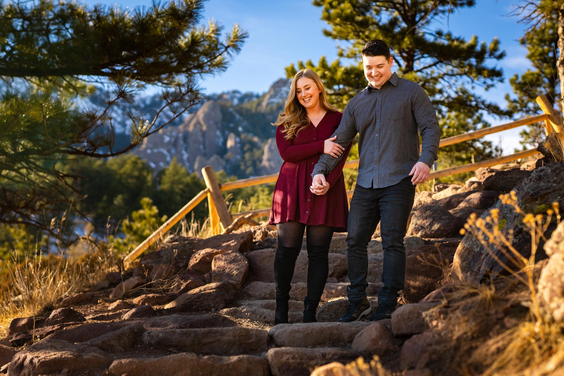 Engaged couple holds hands and walks down a path together, Mountain Engagement Photos, Engagement Session, Engagement Photos, Engagement Photos Inspiration, Engagement Photography, Engagement Photographer, Engagement Portraits, Winter Engagement Photos, Snow Engagement Photos, Boulder engagement session, Boulder engagement photos, Boulder engagement photography, Boulder engagement photographer, Boulder engagement inspiration, NCAR Trail engagement session, NCAR Trail engagement photos, NCAR Trail engagement photography, NCAR Trail engagement photographer, NCAR Trail engagement inspiration, Colorado engagement session, Colorado engagement photos, Colorado engagement photography, Colorado engagement photographer, Colorado engagement inspiration, Flatiron Engagement Photos