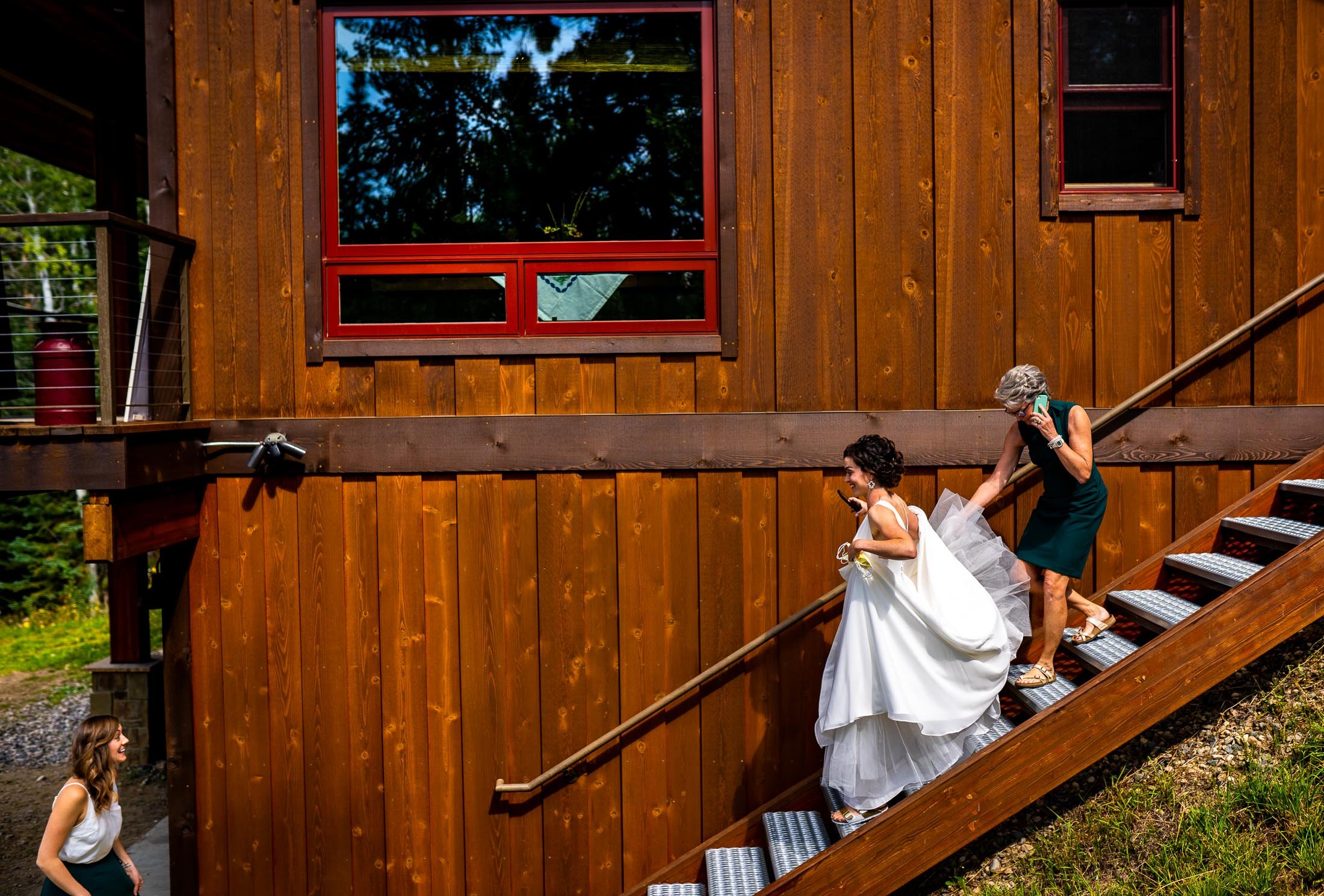 Bride walks down the stairs with the help of her mother at her family's home in the mountains, wedding, wedding photos, wedding photography, wedding photographer, wedding inspiration, wedding photo inspiration, wedding portraits, wedding ceremony, wedding reception, mountain wedding, Catholic Church wedding, Catholic Church wedding photos, Catholic Church wedding photography, Catholic Church wedding photographer, Catholic Church wedding inspiration, Catholic Church wedding venue, Steamboat Springs wedding, Steamboat Springs wedding photos, Steamboat Springs wedding photography, Steamboat Springs wedding photographer, Colorado wedding, Colorado wedding photos, Colorado wedding photography, Colorado wedding photographer, Colorado mountain wedding, Colorado wedding inspiration