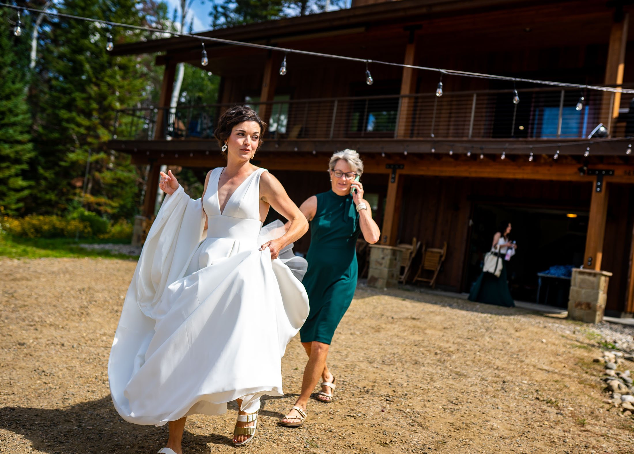 Bride walks to the shuttle with the help of her mother at her family's home in the mountains, wedding, wedding photos, wedding photography, wedding photographer, wedding inspiration, wedding photo inspiration, wedding portraits, wedding ceremony, wedding reception, mountain wedding, Catholic Church wedding, Catholic Church wedding photos, Catholic Church wedding photography, Catholic Church wedding photographer, Catholic Church wedding inspiration, Catholic Church wedding venue, Steamboat Springs wedding, Steamboat Springs wedding photos, Steamboat Springs wedding photography, Steamboat Springs wedding photographer, Colorado wedding, Colorado wedding photos, Colorado wedding photography, Colorado wedding photographer, Colorado mountain wedding, Colorado wedding inspiration