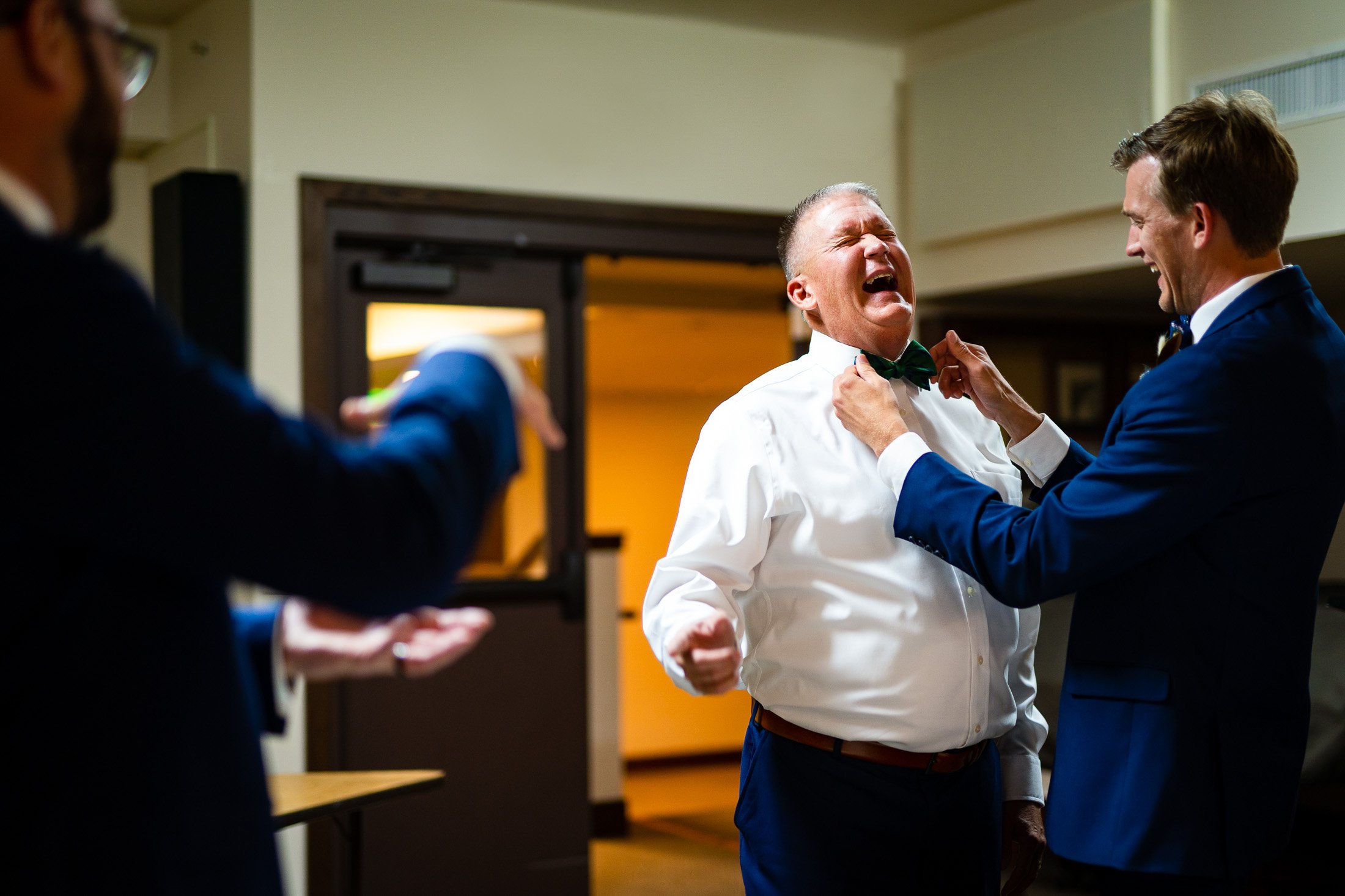 Groom ties the bowtie on his father prior to the wedding ceremony, wedding, wedding photos, wedding photography, wedding photographer, wedding inspiration, wedding photo inspiration, wedding portraits, wedding ceremony, wedding reception, mountain wedding, Catholic Church wedding, Catholic Church wedding photos, Catholic Church wedding photography, Catholic Church wedding photographer, Catholic Church wedding inspiration, Catholic Church wedding venue, Steamboat Springs wedding, Steamboat Springs wedding photos, Steamboat Springs wedding photography, Steamboat Springs wedding photographer, Colorado wedding, Colorado wedding photos, Colorado wedding photography, Colorado wedding photographer, Colorado mountain wedding, Colorado wedding inspiration