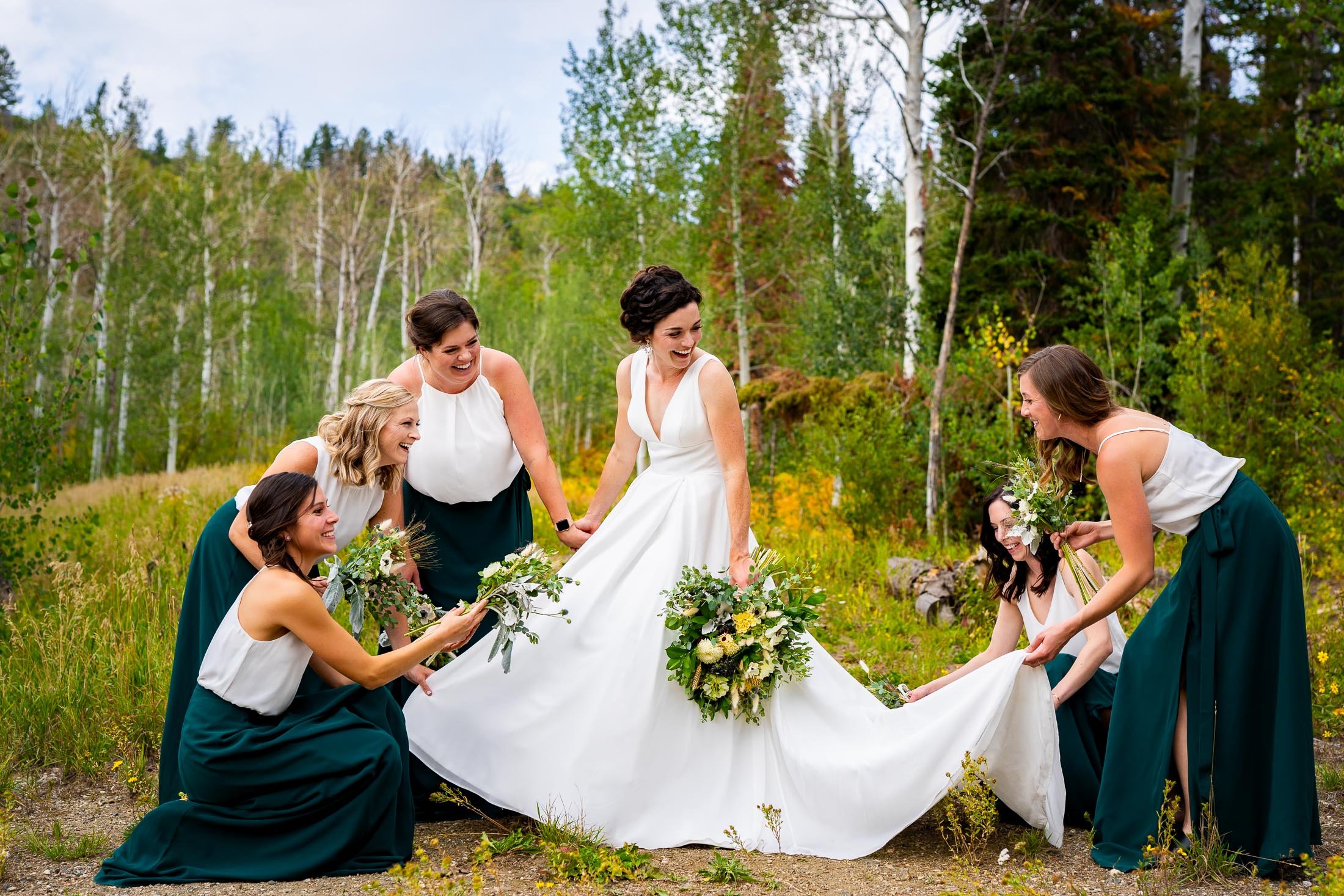 Bride and bridesmaids pose for a portrait surrounded by aspens in a meadow, wedding, wedding photos, wedding photography, wedding photographer, wedding inspiration, wedding photo inspiration, wedding portraits, wedding ceremony, wedding reception, mountain wedding, Catholic Church wedding, Catholic Church wedding photos, Catholic Church wedding photography, Catholic Church wedding photographer, Catholic Church wedding inspiration, Catholic Church wedding venue, Steamboat Springs wedding, Steamboat Springs wedding photos, Steamboat Springs wedding photography, Steamboat Springs wedding photographer, Colorado wedding, Colorado wedding photos, Colorado wedding photography, Colorado wedding photographer, Colorado mountain wedding, Colorado wedding inspiration