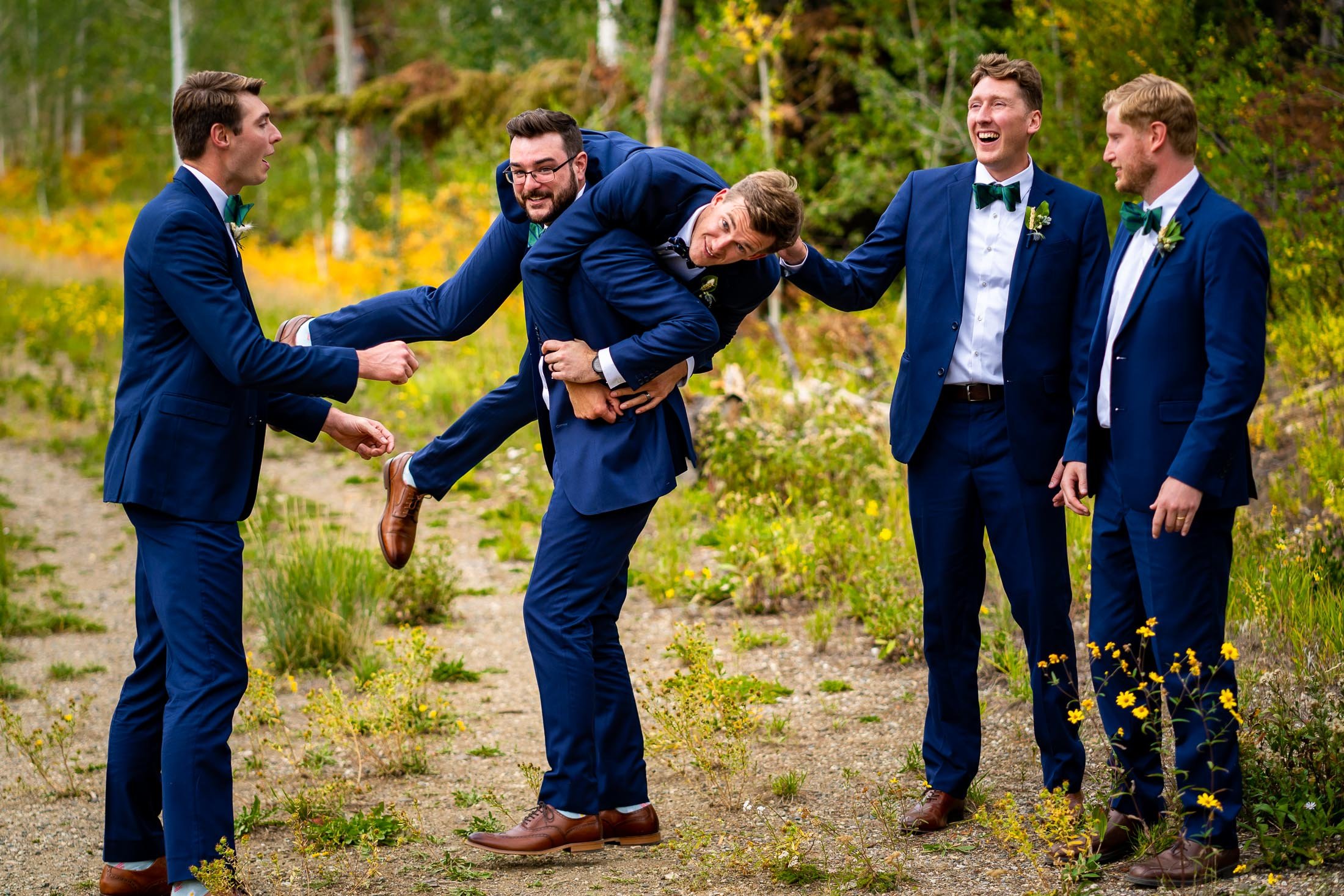 Groomsmen lift groom up during a portrait surrounded by aspens in a meadow, wedding, wedding photos, wedding photography, wedding photographer, wedding inspiration, wedding photo inspiration, wedding portraits, wedding ceremony, wedding reception, mountain wedding, Catholic Church wedding, Catholic Church wedding photos, Catholic Church wedding photography, Catholic Church wedding photographer, Catholic Church wedding inspiration, Catholic Church wedding venue, Steamboat Springs wedding, Steamboat Springs wedding photos, Steamboat Springs wedding photography, Steamboat Springs wedding photographer, Colorado wedding, Colorado wedding photos, Colorado wedding photography, Colorado wedding photographer, Colorado mountain wedding, Colorado wedding inspiration