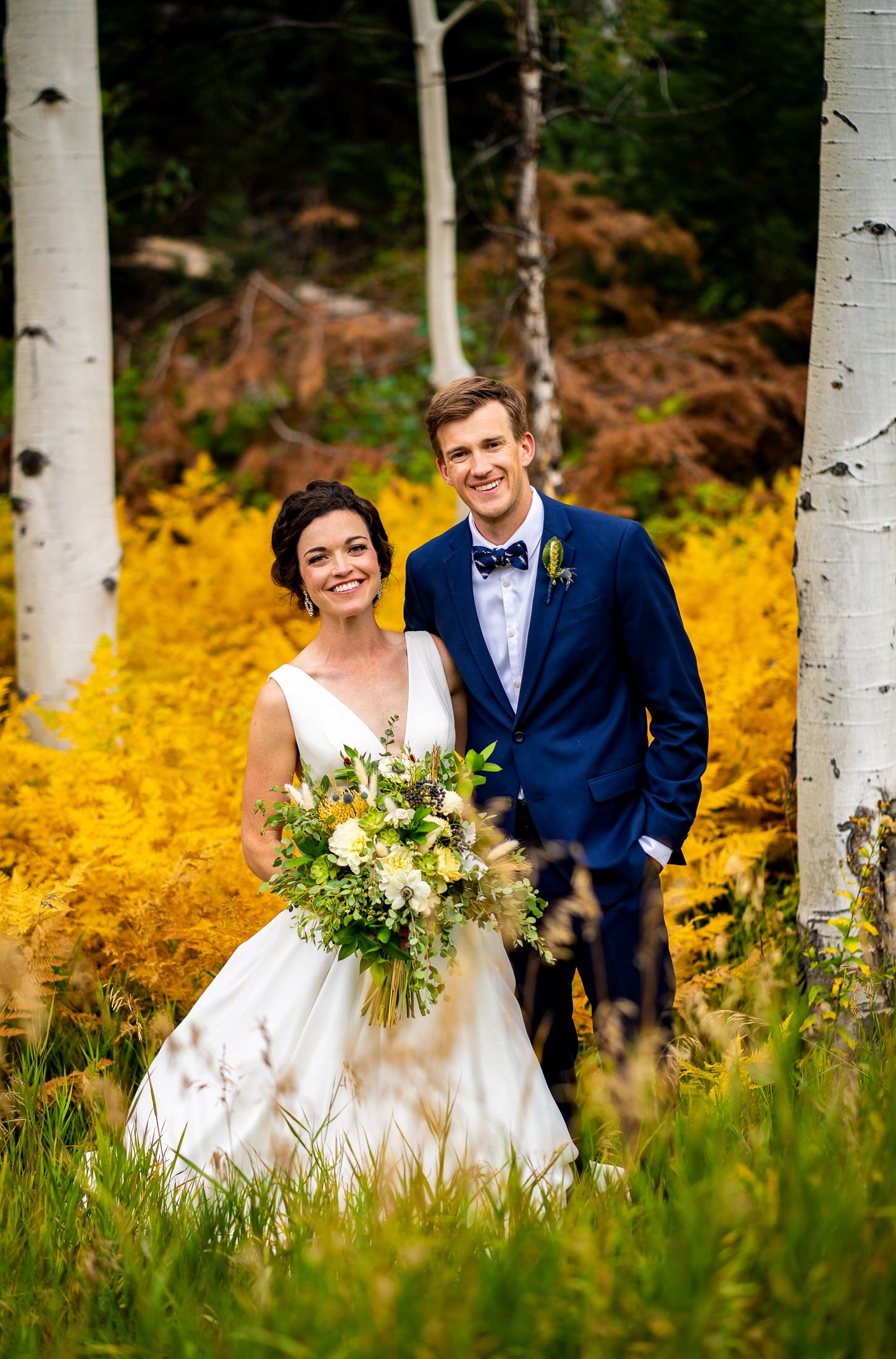 Bride and groom pose for a portrait in a field of golden ferns surrounded by aspens in a meadow, wedding, wedding photos, wedding photography, wedding photographer, wedding inspiration, wedding photo inspiration, wedding portraits, wedding ceremony, wedding reception, mountain wedding, Catholic Church wedding, Catholic Church wedding photos, Catholic Church wedding photography, Catholic Church wedding photographer, Catholic Church wedding inspiration, Catholic Church wedding venue, Steamboat Springs wedding, Steamboat Springs wedding photos, Steamboat Springs wedding photography, Steamboat Springs wedding photographer, Colorado wedding, Colorado wedding photos, Colorado wedding photography, Colorado wedding photographer, Colorado mountain wedding, Colorado wedding inspiration