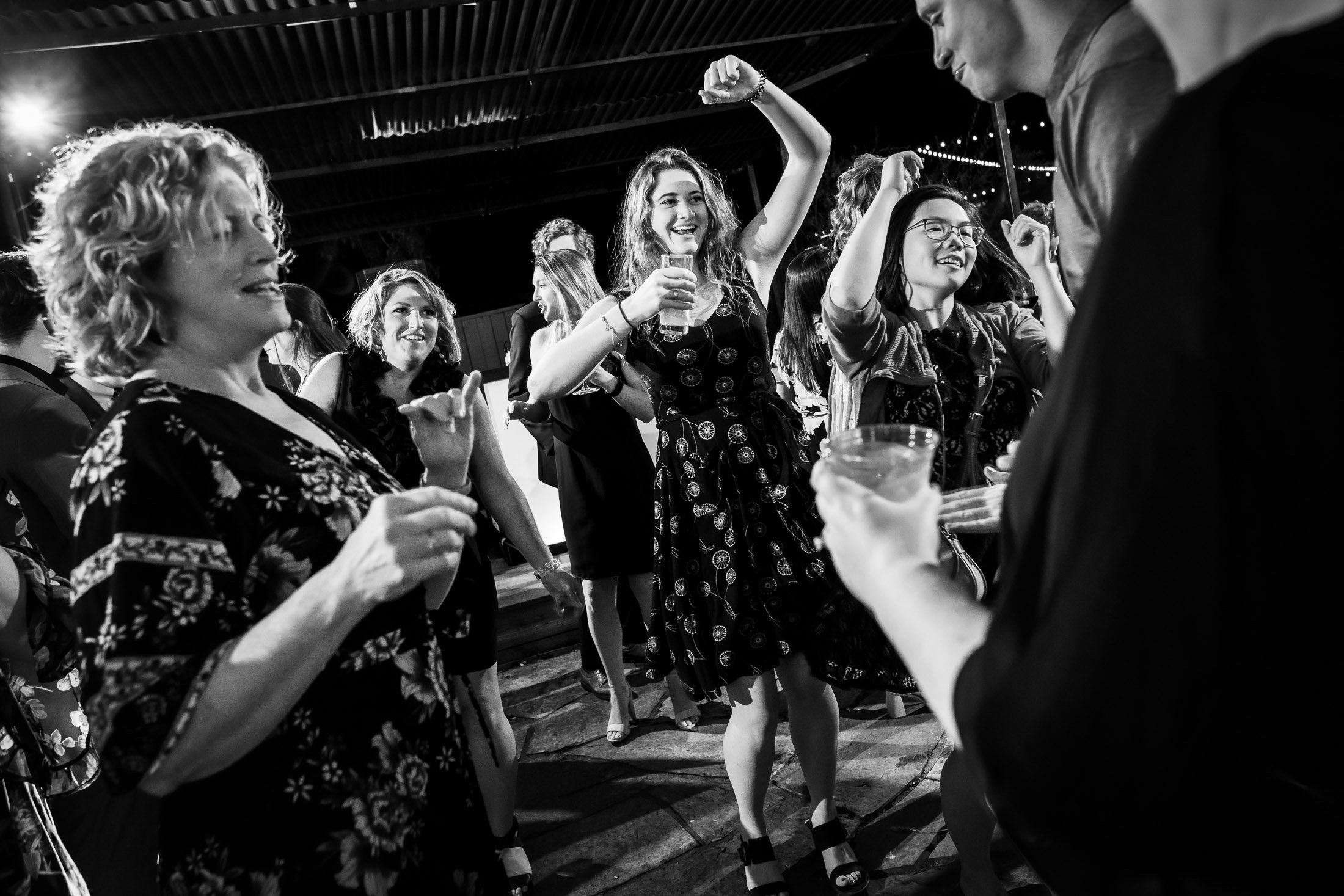 Guests dance to music on the outdoor patio under cafe lights during the wedding reception, wedding, wedding photos, wedding photography, wedding photographer, wedding inspiration, wedding photo inspiration, wedding portraits, wedding ceremony, wedding reception, mountain wedding, Catholic Church wedding, Catholic Church wedding photos, Catholic Church wedding photography, Catholic Church wedding photographer, Catholic Church wedding inspiration, Catholic Church wedding venue, Steamboat Springs wedding, Steamboat Springs wedding photos, Steamboat Springs wedding photography, Steamboat Springs wedding photographer, Colorado wedding, Colorado wedding photos, Colorado wedding photography, Colorado wedding photographer, Colorado mountain wedding, Colorado wedding inspiration