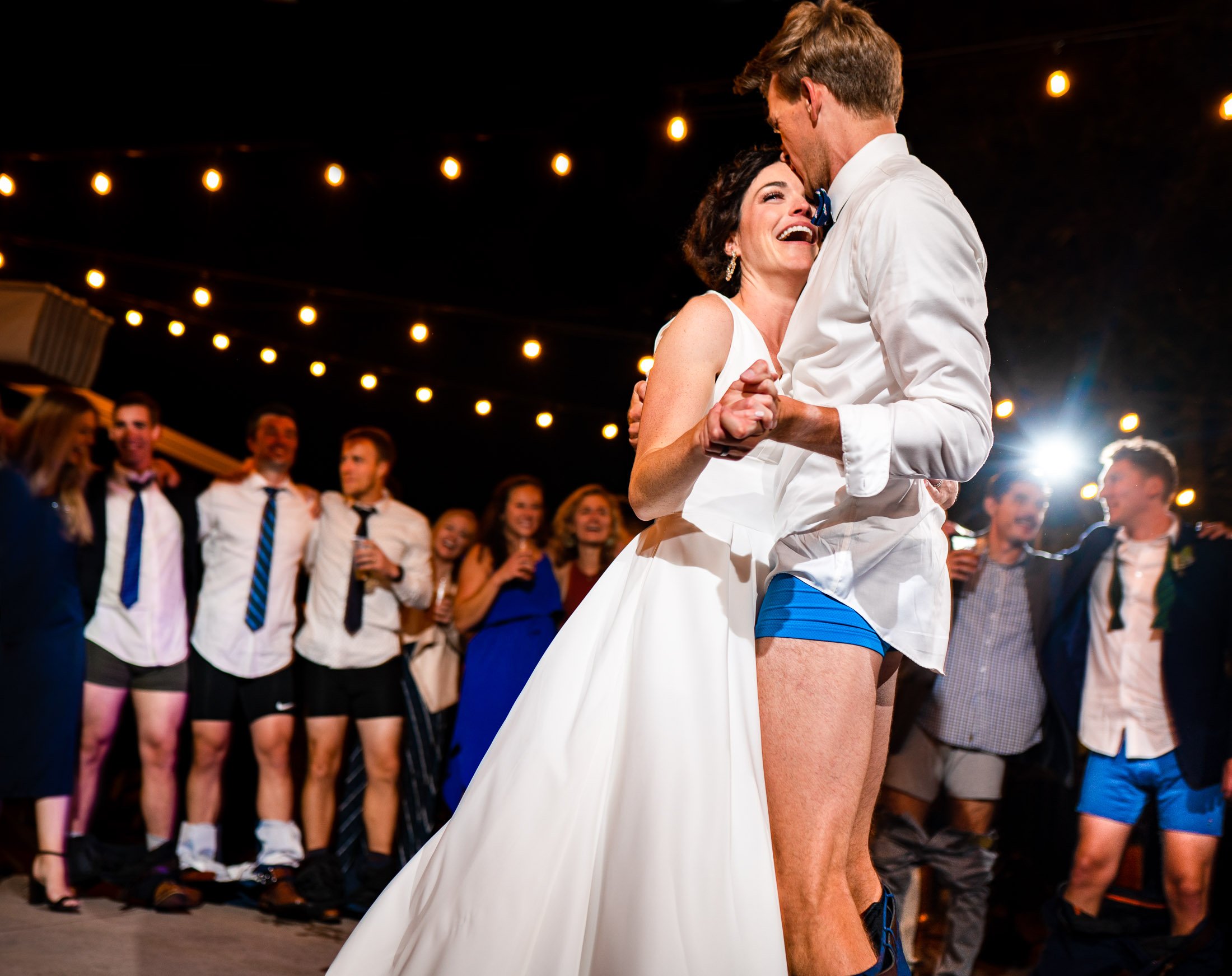 Bride and groom dance together while groom is wearing only his boxers on the outdoor patio under cafe lights during the wedding reception, wedding, wedding photos, wedding photography, wedding photographer, wedding inspiration, wedding photo inspiration, wedding portraits, wedding ceremony, wedding reception, mountain wedding, Catholic Church wedding, Catholic Church wedding photos, Catholic Church wedding photography, Catholic Church wedding photographer, Catholic Church wedding inspiration, Catholic Church wedding venue, Steamboat Springs wedding, Steamboat Springs wedding photos, Steamboat Springs wedding photography, Steamboat Springs wedding photographer, Colorado wedding, Colorado wedding photos, Colorado wedding photography, Colorado wedding photographer, Colorado mountain wedding, Colorado wedding inspiration