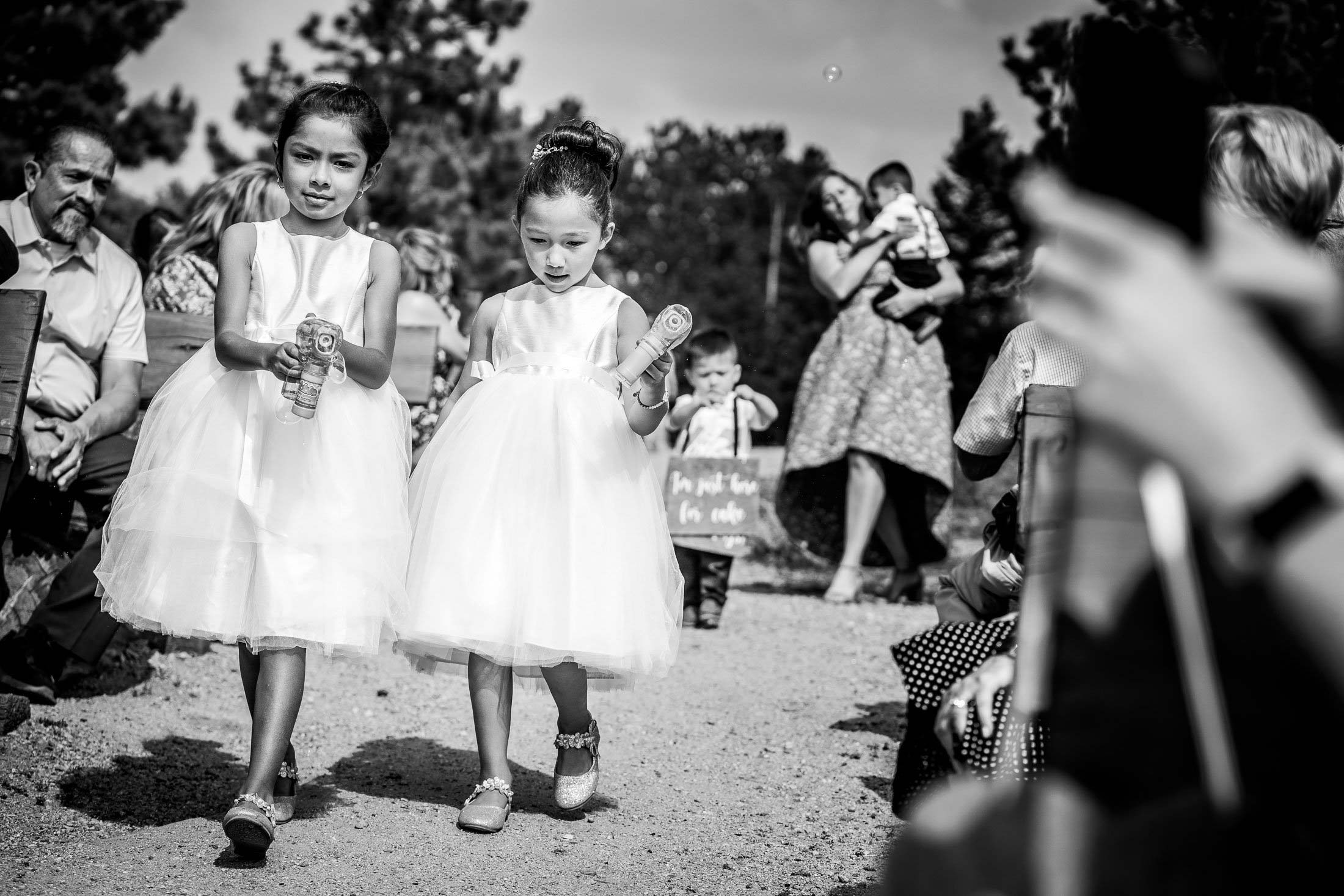 Flower girls walk down the aisle during the processional at their  wedding ceremony in the mountains, wedding photos, wedding photography, wedding photographer, wedding inspiration, wedding photo inspiration, mountain wedding, YMCA of the Rockies wedding, YMCA of the Rockies wedding photos, YMCA of the Rockies wedding photography, YMCA of the Rockies wedding photographer, YMCA of the Rockies wedding inspiration, YMCA of the Rockies wedding venue, Estes Park wedding, Estes Park wedding photos, Estes Park wedding photography, Estes Park wedding photographer, Colorado wedding, Colorado wedding photos, Colorado wedding photography, Colorado wedding photographer, Colorado mountain wedding, Colorado wedding inspiration