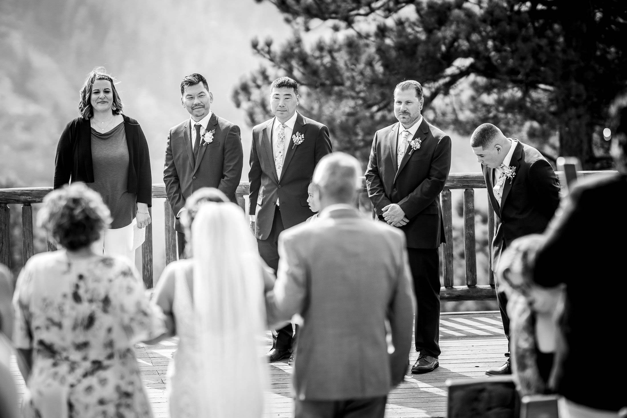 Groom watches as the bride walks down the aisle during the processional at their  wedding ceremony in the mountains, wedding photos, wedding photography, wedding photographer, wedding inspiration, wedding photo inspiration, mountain wedding, YMCA of the Rockies wedding, YMCA of the Rockies wedding photos, YMCA of the Rockies wedding photography, YMCA of the Rockies wedding photographer, YMCA of the Rockies wedding inspiration, YMCA of the Rockies wedding venue, Estes Park wedding, Estes Park wedding photos, Estes Park wedding photography, Estes Park wedding photographer, Colorado wedding, Colorado wedding photos, Colorado wedding photography, Colorado wedding photographer, Colorado mountain wedding, Colorado wedding inspiration