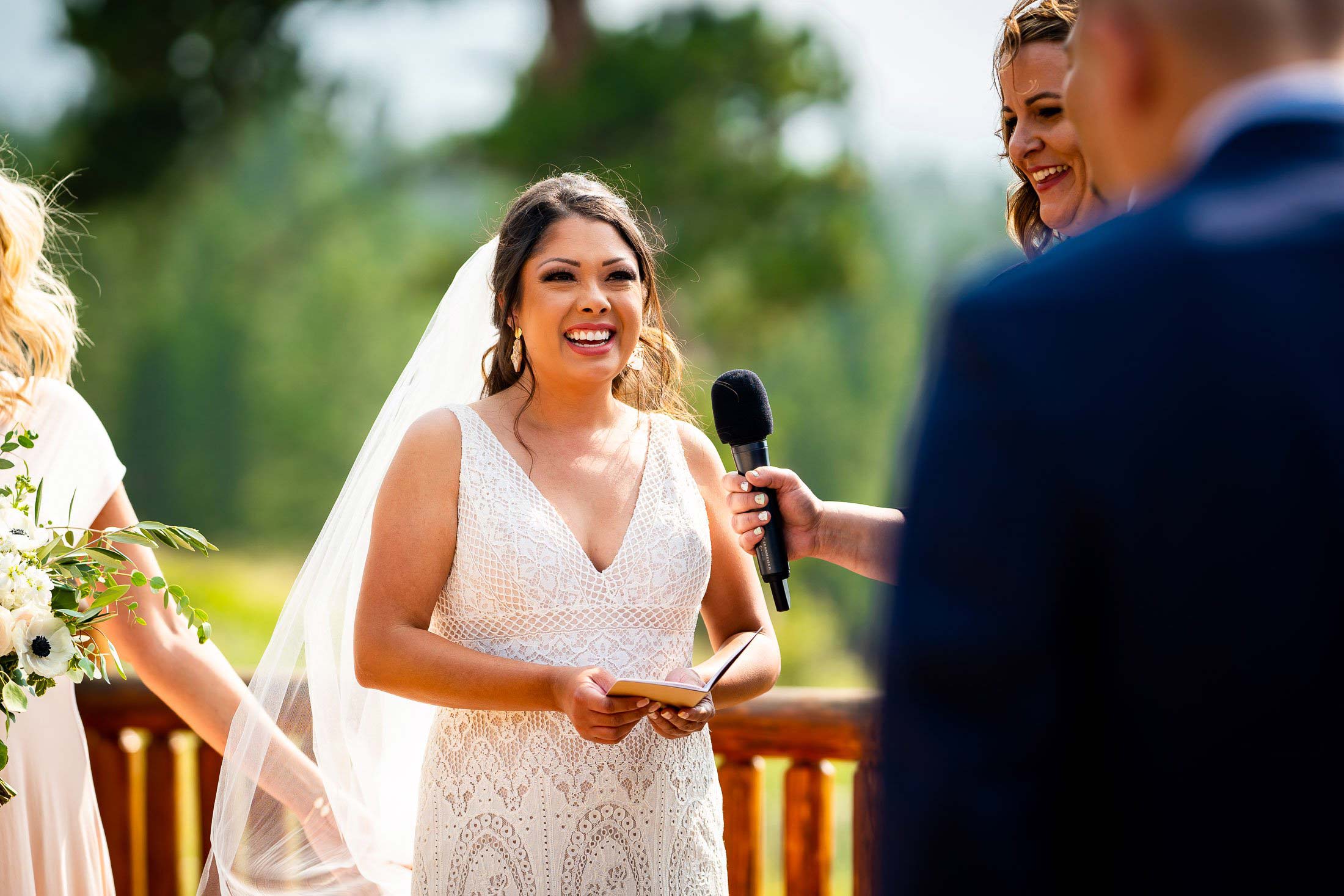 Bride reads her wedding vows during their wedding ceremony in the mountains as their wedding party stands by their side, wedding photos, wedding photography, wedding photographer, wedding inspiration, wedding photo inspiration, mountain wedding, YMCA of the Rockies wedding, YMCA of the Rockies wedding photos, YMCA of the Rockies wedding photography, YMCA of the Rockies wedding photographer, YMCA of the Rockies wedding inspiration, YMCA of the Rockies wedding venue, Estes Park wedding, Estes Park wedding photos, Estes Park wedding photography, Estes Park wedding photographer, Colorado wedding, Colorado wedding photos, Colorado wedding photography, Colorado wedding photographer, Colorado mountain wedding, Colorado wedding inspiration