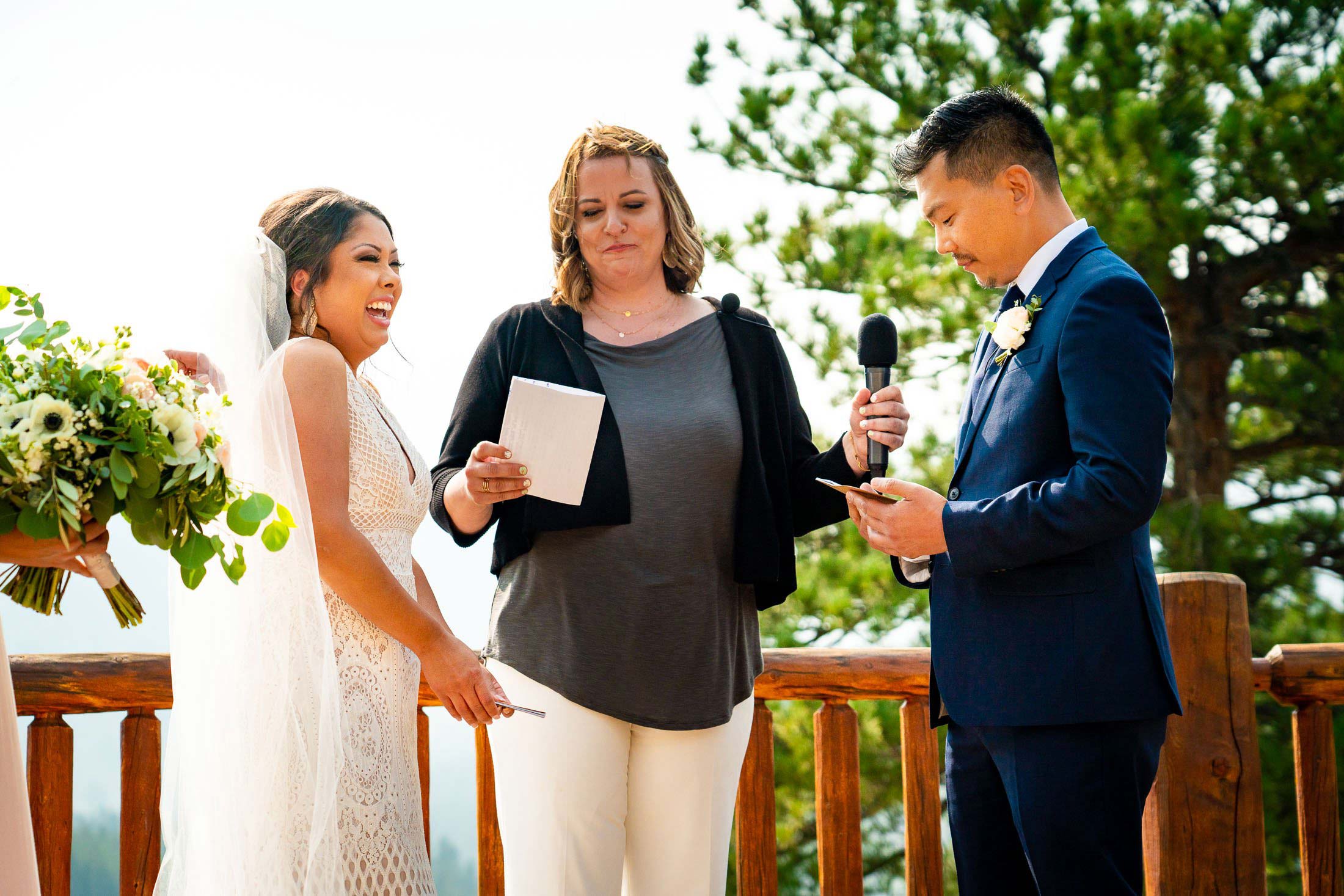 Groom reads his wedding vows during their wedding ceremony in the mountains as their wedding party stands by their side, wedding photos, wedding photography, wedding photographer, wedding inspiration, wedding photo inspiration, mountain wedding, YMCA of the Rockies wedding, YMCA of the Rockies wedding photos, YMCA of the Rockies wedding photography, YMCA of the Rockies wedding photographer, YMCA of the Rockies wedding inspiration, YMCA of the Rockies wedding venue, Estes Park wedding, Estes Park wedding photos, Estes Park wedding photography, Estes Park wedding photographer, Colorado wedding, Colorado wedding photos, Colorado wedding photography, Colorado wedding photographer, Colorado mountain wedding, Colorado wedding inspiration