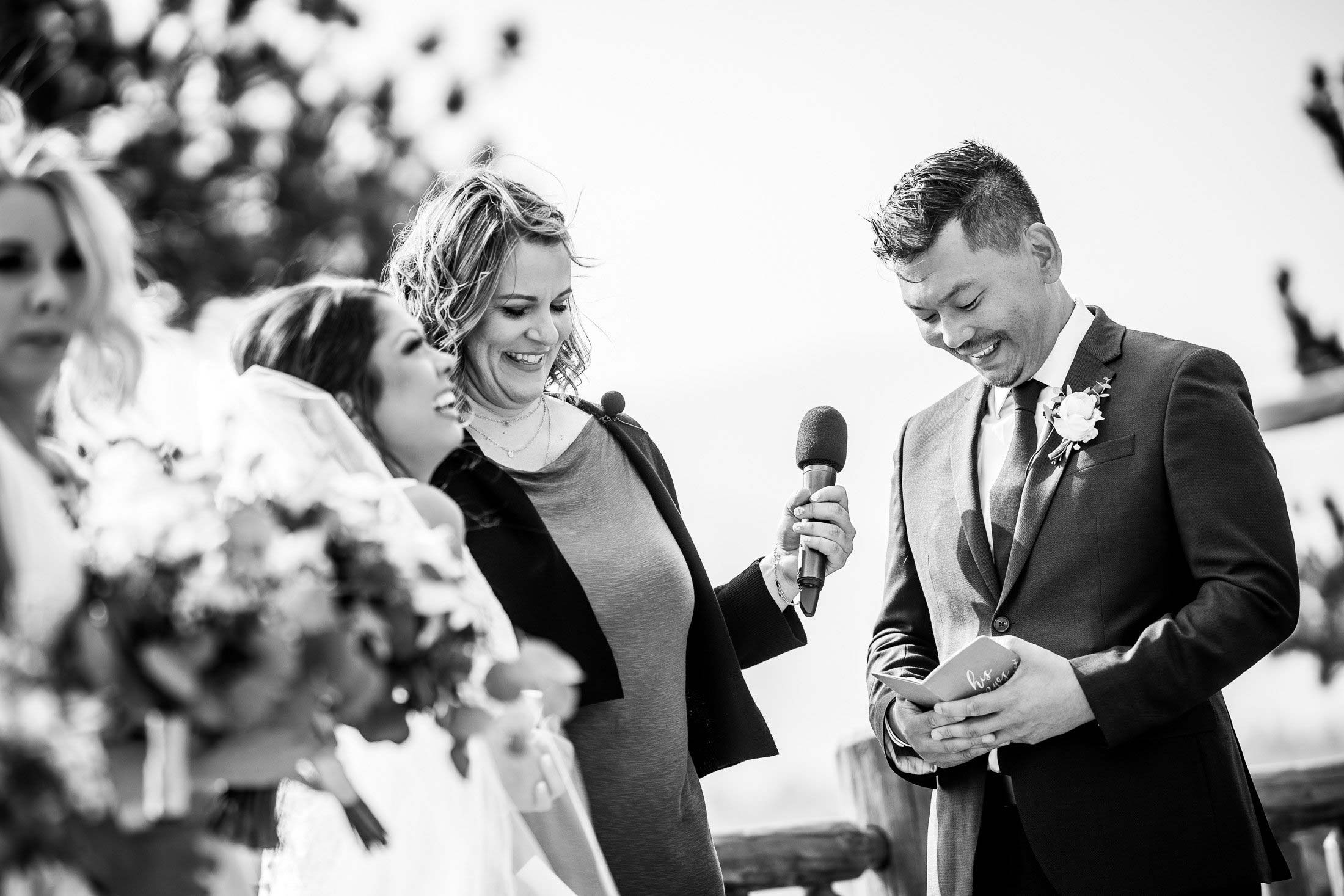 Groom reads his wedding vows during their wedding ceremony in the mountains as their wedding party stands by their side, wedding photos, wedding photography, wedding photographer, wedding inspiration, wedding photo inspiration, mountain wedding, YMCA of the Rockies wedding, YMCA of the Rockies wedding photos, YMCA of the Rockies wedding photography, YMCA of the Rockies wedding photographer, YMCA of the Rockies wedding inspiration, YMCA of the Rockies wedding venue, Estes Park wedding, Estes Park wedding photos, Estes Park wedding photography, Estes Park wedding photographer, Colorado wedding, Colorado wedding photos, Colorado wedding photography, Colorado wedding photographer, Colorado mountain wedding, Colorado wedding inspiration