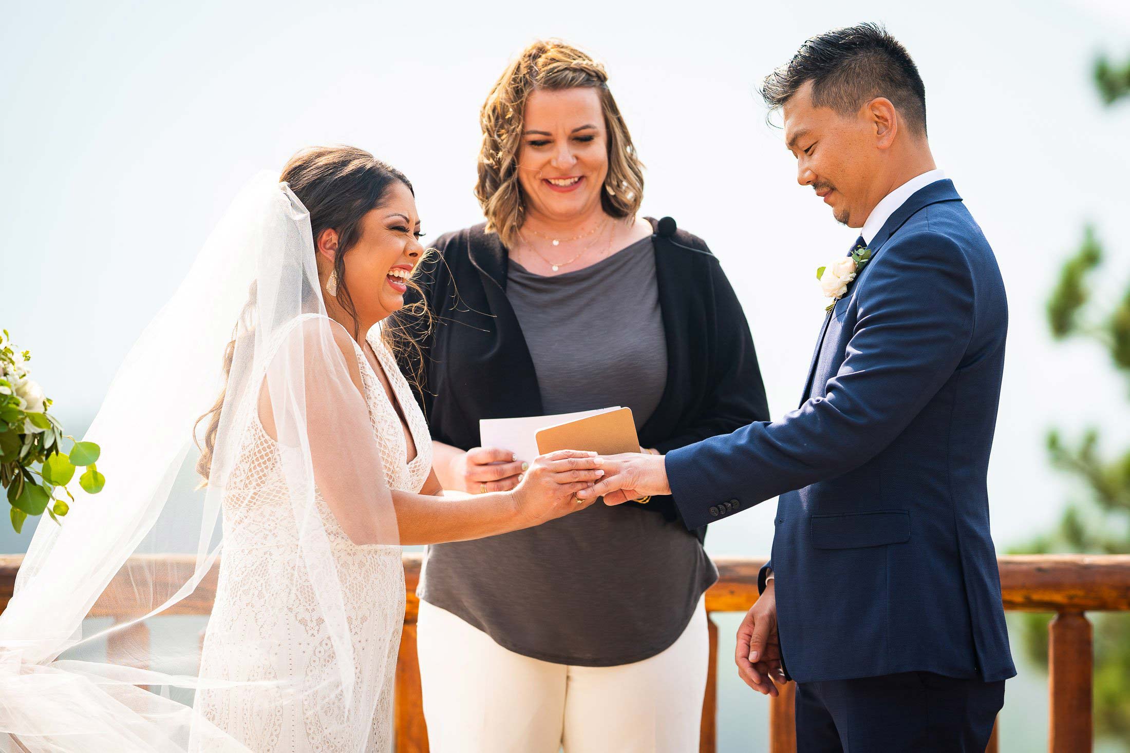 Bride and groom exchange wedding rings during their wedding ceremony in the mountains as their wedding party stands by their side, wedding photos, wedding photography, wedding photographer, wedding inspiration, wedding photo inspiration, mountain wedding, YMCA of the Rockies wedding, YMCA of the Rockies wedding photos, YMCA of the Rockies wedding photography, YMCA of the Rockies wedding photographer, YMCA of the Rockies wedding inspiration, YMCA of the Rockies wedding venue, Estes Park wedding, Estes Park wedding photos, Estes Park wedding photography, Estes Park wedding photographer, Colorado wedding, Colorado wedding photos, Colorado wedding photography, Colorado wedding photographer, Colorado mountain wedding, Colorado wedding inspiration