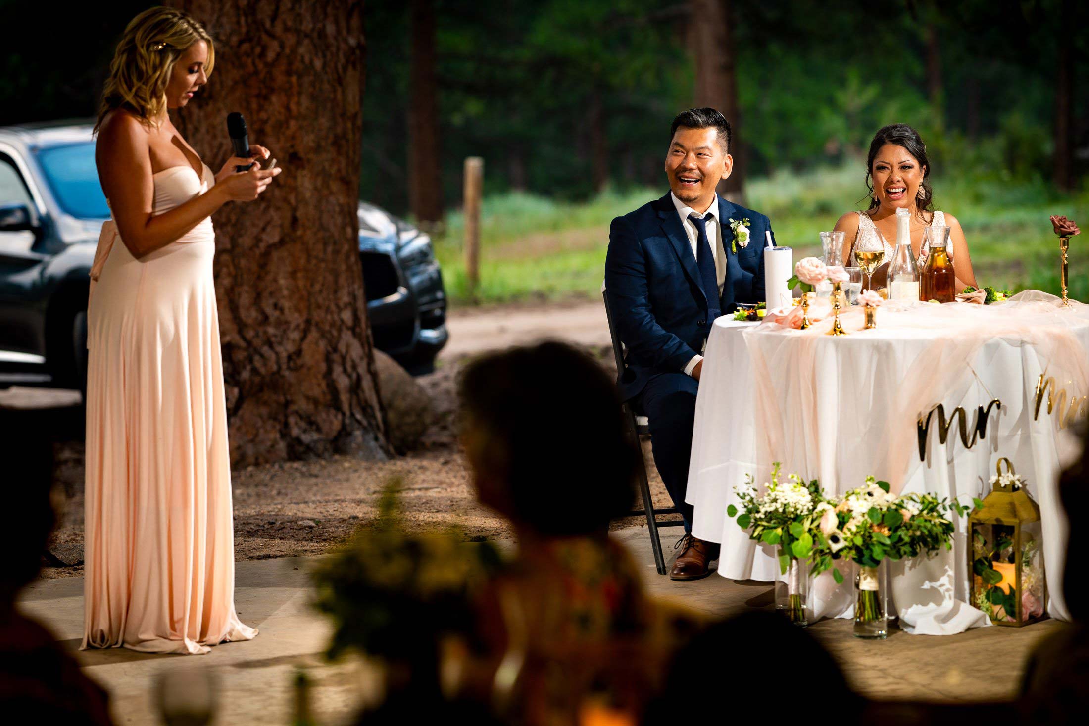 Bride and groom laugh during a toast by a the maid of honor during the reception, wedding photos, wedding photography, wedding photographer, wedding inspiration, wedding photo inspiration, mountain wedding, YMCA of the Rockies wedding, YMCA of the Rockies wedding photos, YMCA of the Rockies wedding photography, YMCA of the Rockies wedding photographer, YMCA of the Rockies wedding inspiration, YMCA of the Rockies wedding venue, Estes Park wedding, Estes Park wedding photos, Estes Park wedding photography, Estes Park wedding photographer, Colorado wedding, Colorado wedding photos, Colorado wedding photography, Colorado wedding photographer, Colorado mountain wedding, Colorado wedding inspiration