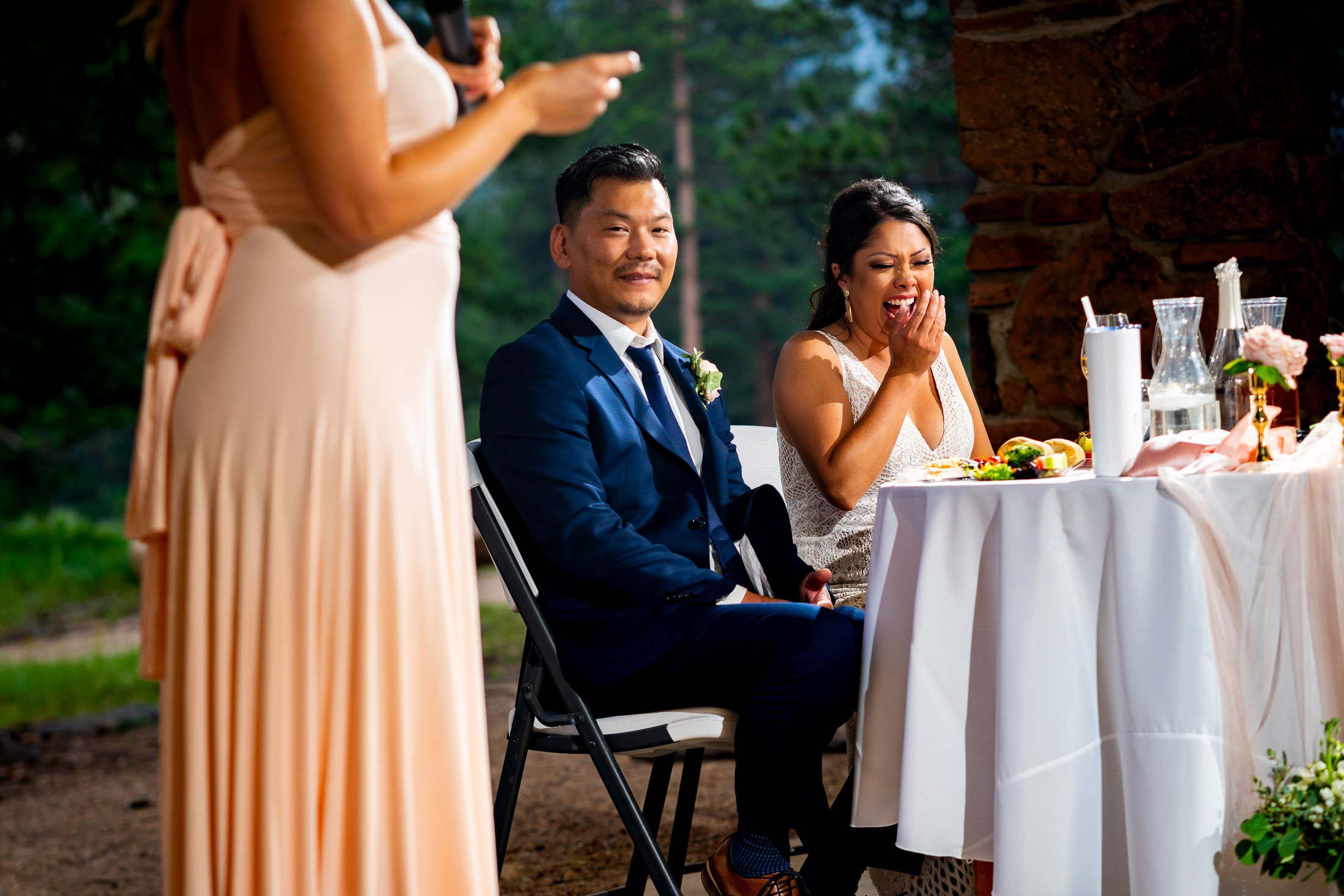 Bride and groom laugh during a toast by a the maid of honor during the reception, wedding photos, wedding photography, wedding photographer, wedding inspiration, wedding photo inspiration, mountain wedding, YMCA of the Rockies wedding, YMCA of the Rockies wedding photos, YMCA of the Rockies wedding photography, YMCA of the Rockies wedding photographer, YMCA of the Rockies wedding inspiration, YMCA of the Rockies wedding venue, Estes Park wedding, Estes Park wedding photos, Estes Park wedding photography, Estes Park wedding photographer, Colorado wedding, Colorado wedding photos, Colorado wedding photography, Colorado wedding photographer, Colorado mountain wedding, Colorado wedding inspiration