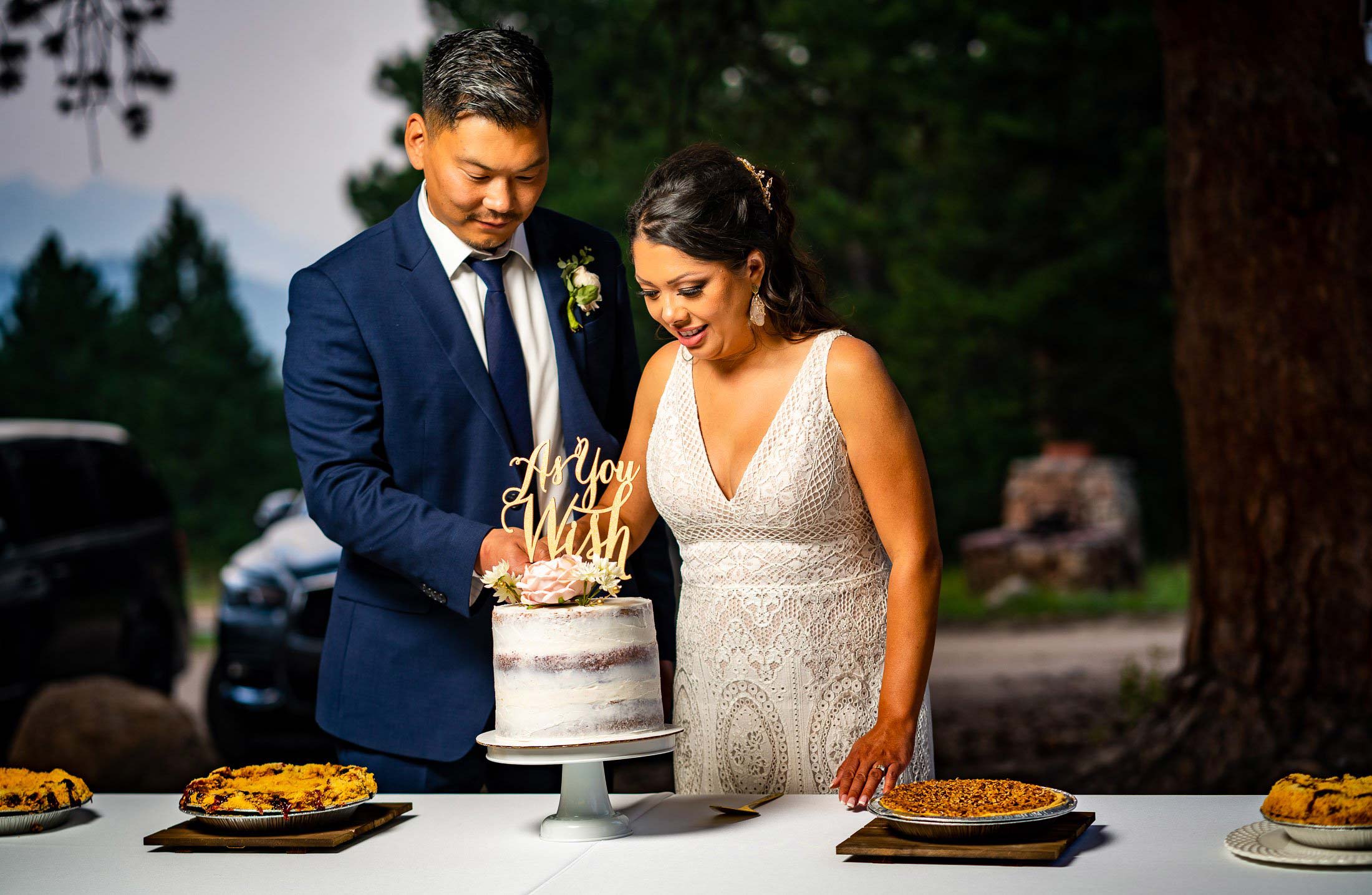 Bride and groom cut their wedding cake during the reception, wedding photos, wedding photography, wedding photographer, wedding inspiration, wedding photo inspiration, mountain wedding, YMCA of the Rockies wedding, YMCA of the Rockies wedding photos, YMCA of the Rockies wedding photography, YMCA of the Rockies wedding photographer, YMCA of the Rockies wedding inspiration, YMCA of the Rockies wedding venue, Estes Park wedding, Estes Park wedding photos, Estes Park wedding photography, Estes Park wedding photographer, Colorado wedding, Colorado wedding photos, Colorado wedding photography, Colorado wedding photographer, Colorado mountain wedding, Colorado wedding inspiration