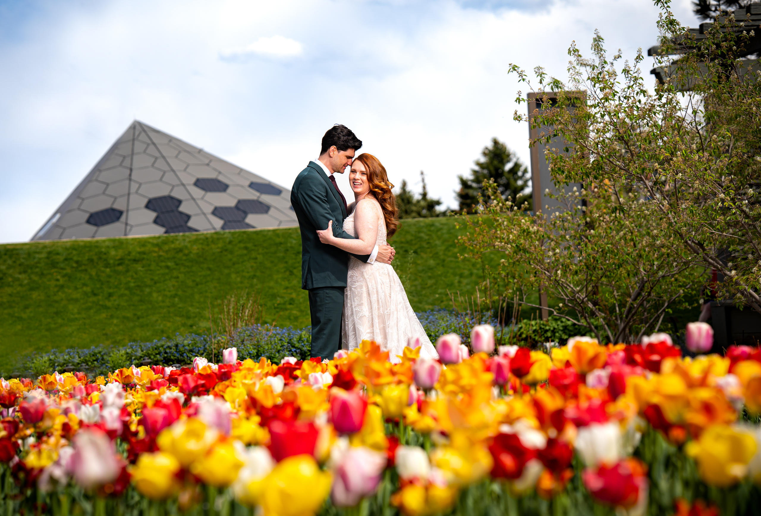 Bride and groom pose for portraits in a field of blossoming tulips in the spring gardens, wedding photos, wedding photography, wedding photographer, wedding photo inspiration, Denver Botanic Garden wedding, Denver Botanic Garden wedding photos, Denver Botanic Garden wedding photography, Denver Botanic Garden wedding inspiration, Denver wedding venue, Denver wedding photos, Denver wedding photography, Denver wedding photographer, Colorado wedding photography