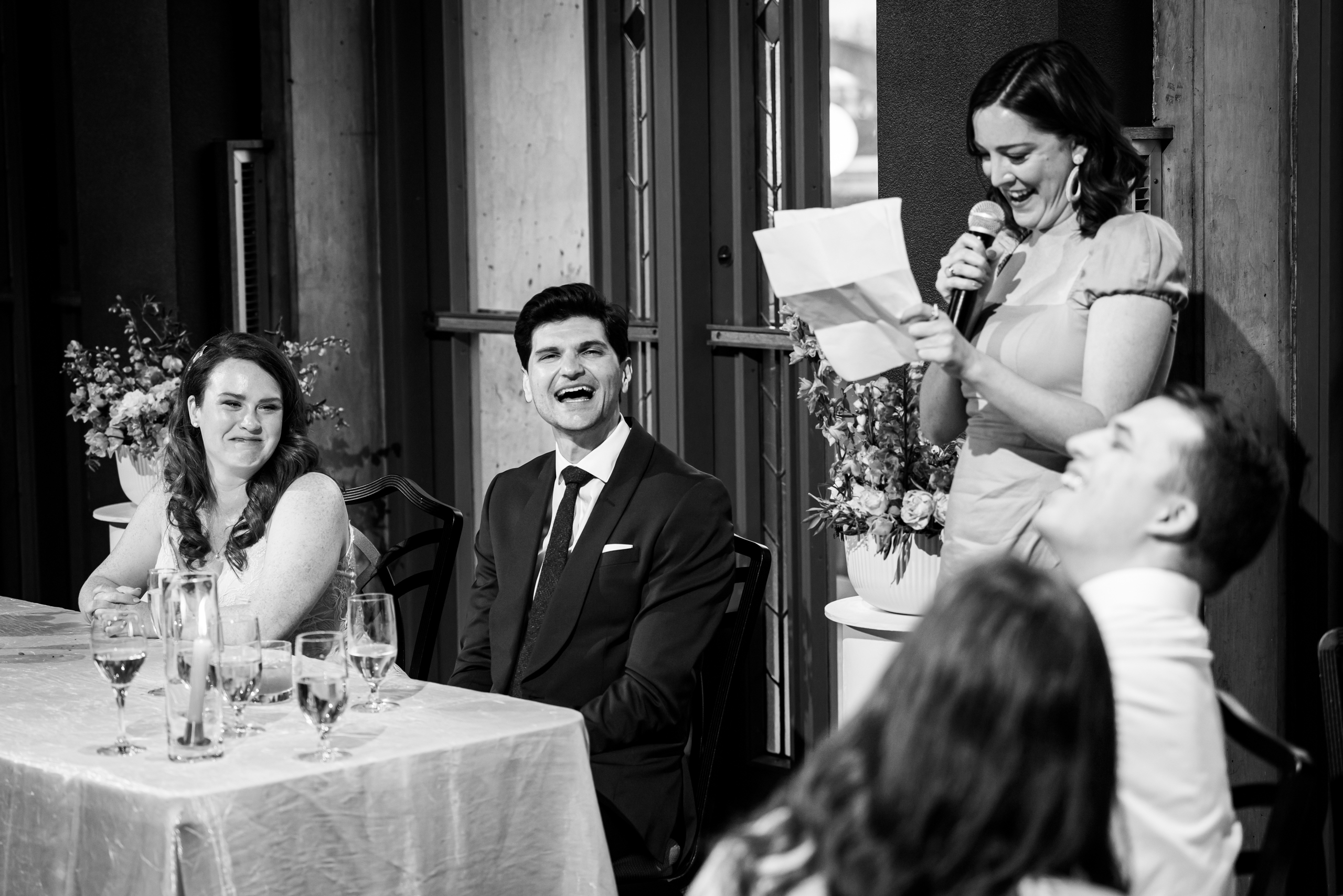 Bride and groom laugh during the bridesmaid's speech at their wedding reception, wedding photos, wedding photography, wedding photographer, wedding photo inspiration, Denver Botanic Garden wedding, Denver Botanic Garden wedding photos, Denver Botanic Garden wedding photography, Denver Botanic Garden wedding inspiration, Denver wedding venue, Denver wedding photos, Denver wedding photography, Denver wedding photographer, Colorado wedding photography