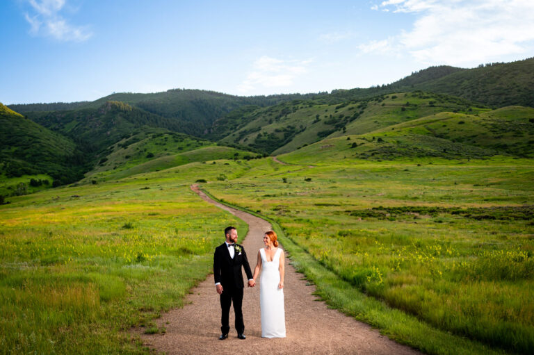 Beautiful portrait of the bride and groom on their wedding day at the Manor House with rolling greens in the background