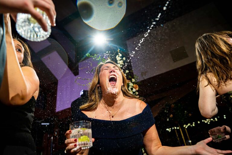 Guest gets sprayed with a champagne gun on the dancefloor during the reception at Donovan Pavilion