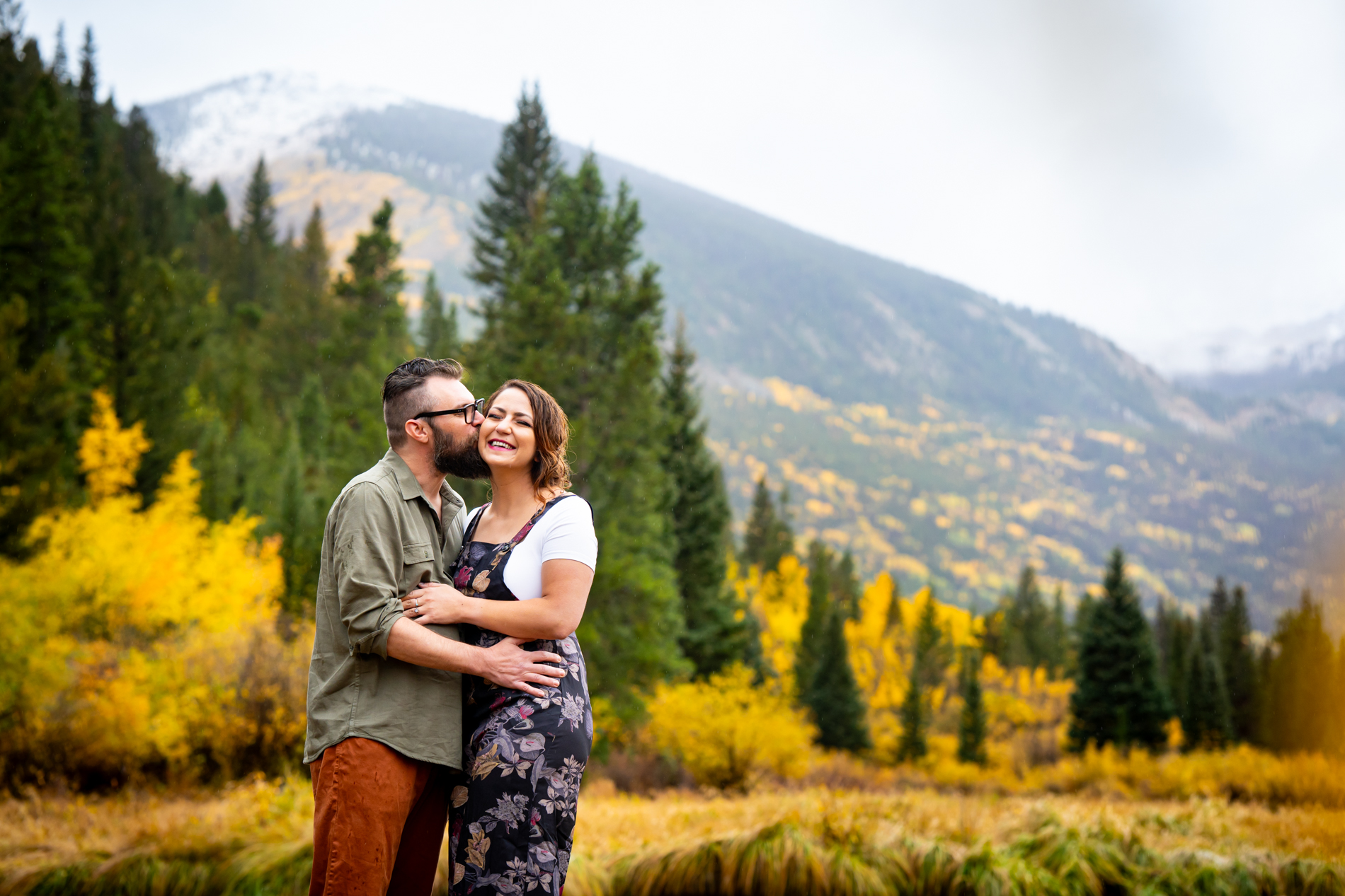 Cottonwood Pass Engagement Photos in Buena Vista with fall foliage, mountains and a winter blizzard