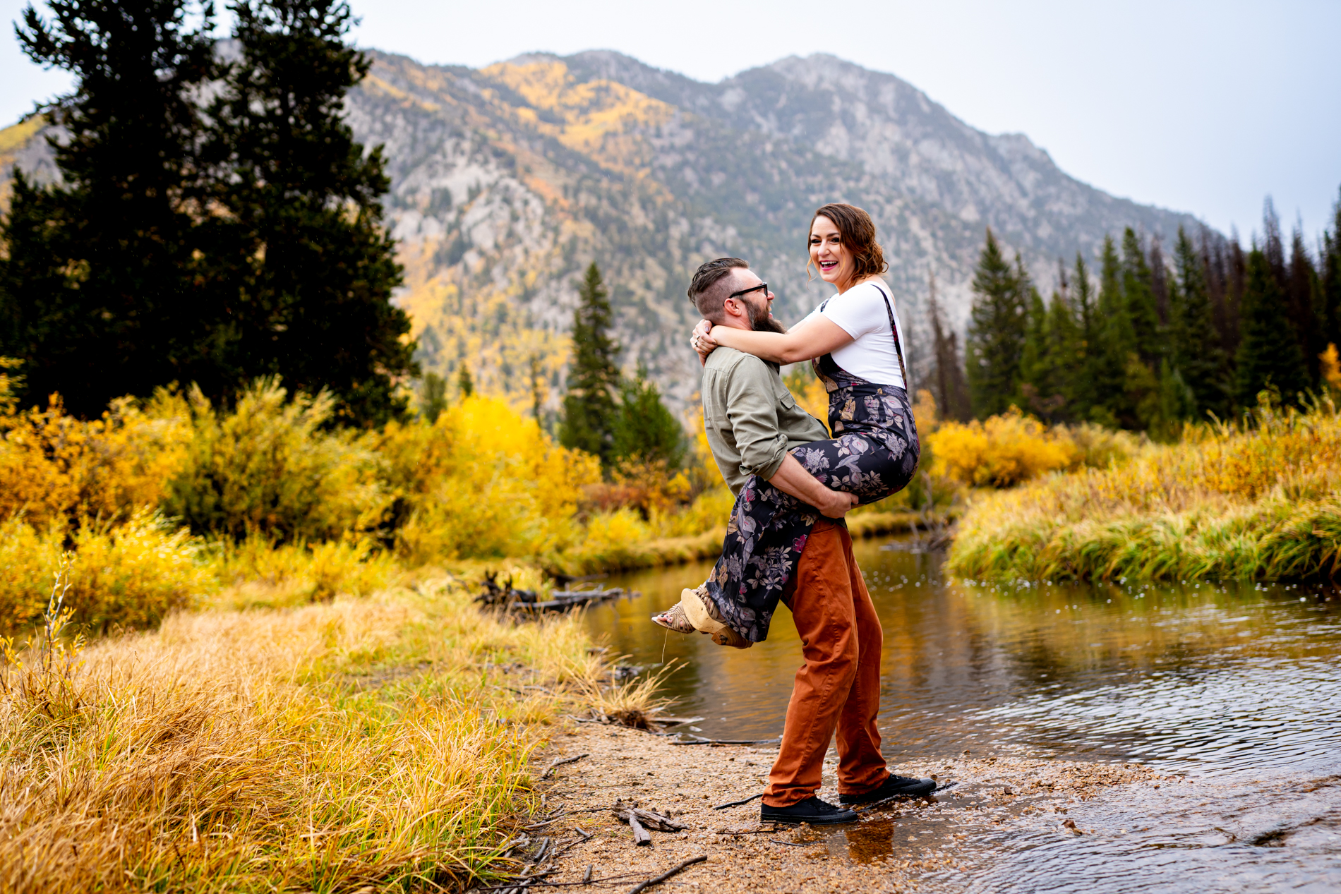 Cottonwood Pass Engagement Photos in Buena Vista with fall foliage, mountains and a winter blizzard