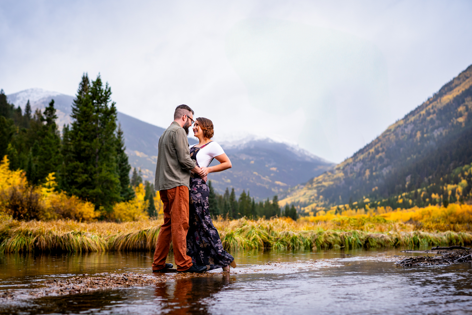 Cottonwood Pass Engagement Photos in Buena Vista with fall foliage, mountains and a winter blizzard