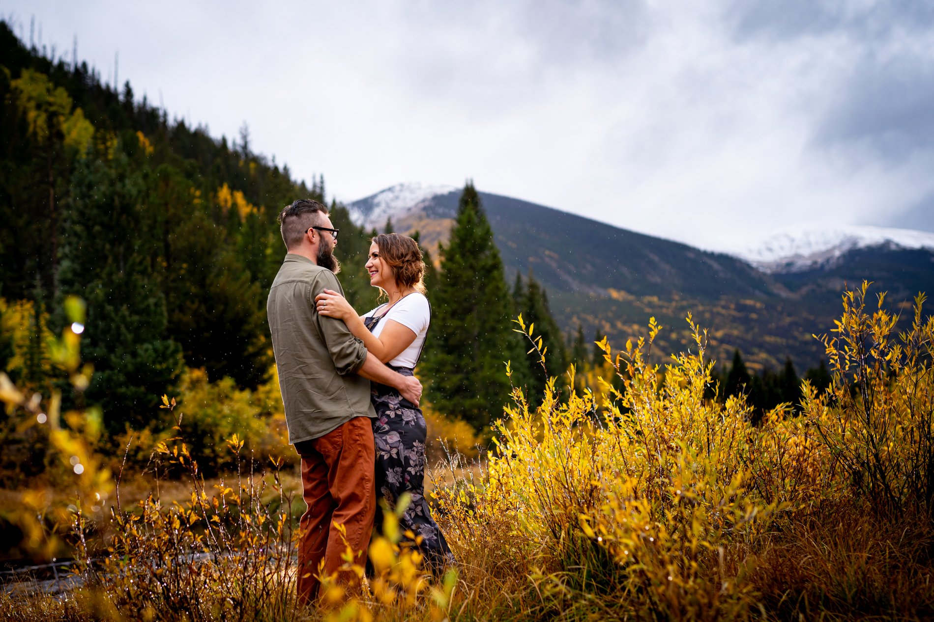 Cottonwood Pass Engagement Photos in Buena Vista with fall foliage, mountains and a winter blizzard