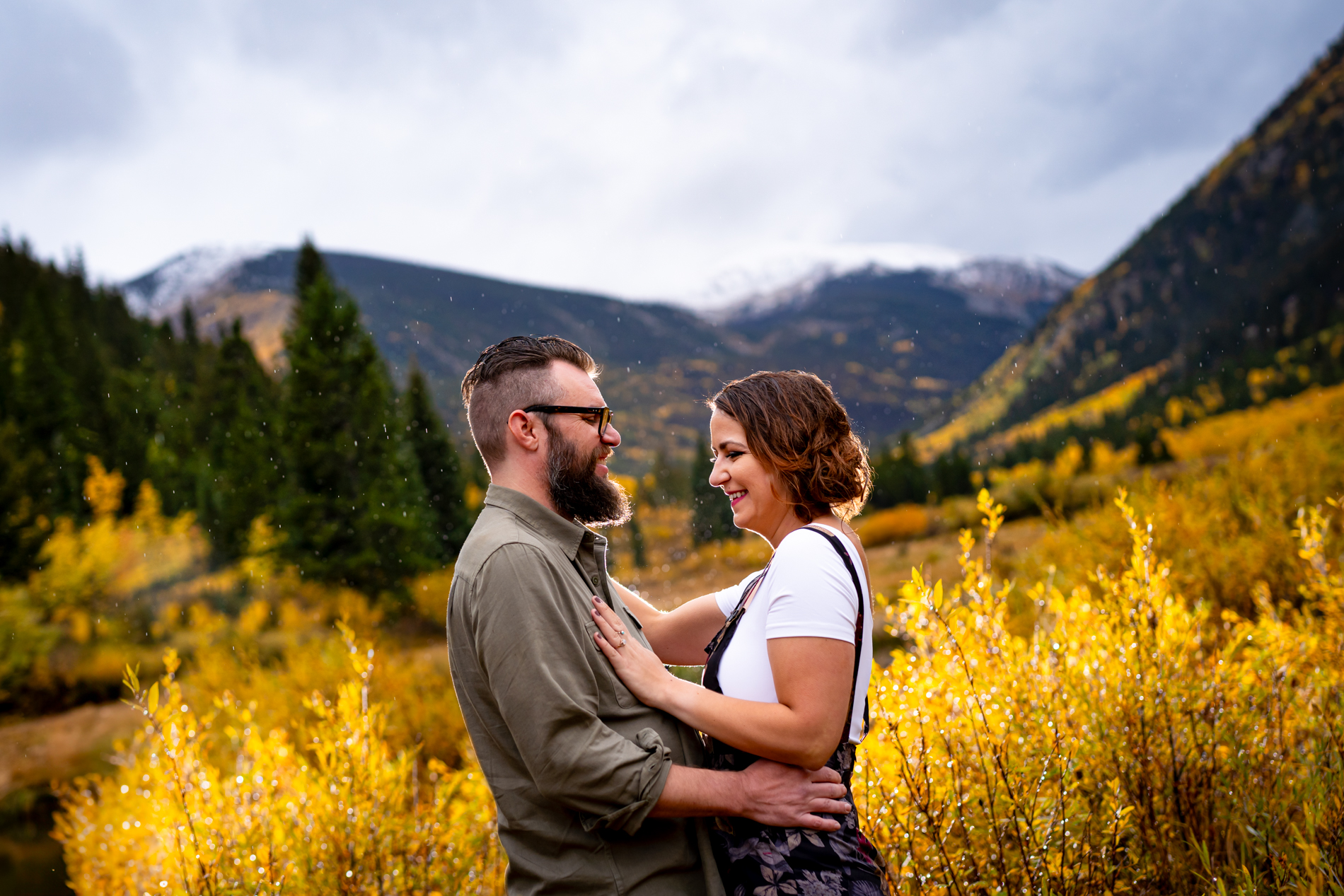 Cottonwood Pass Engagement Photos in Buena Vista with fall foliage, mountains and a winter blizzard