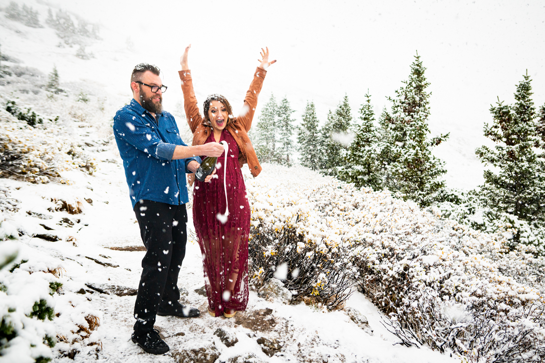 Cottonwood Pass Engagement Photos in Buena Vista with fall foliage, mountains and a winter blizzard