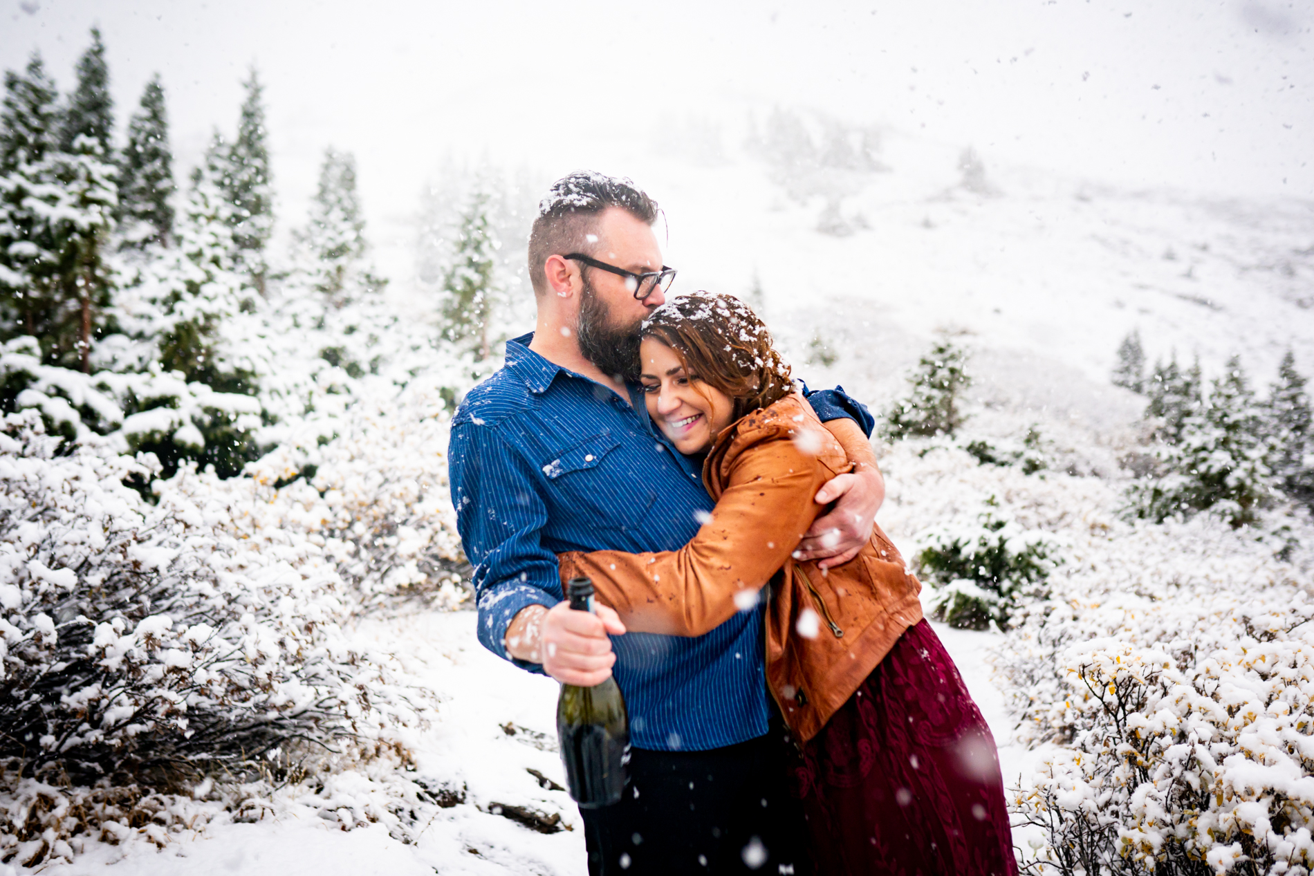 Cottonwood Pass Engagement Photos in Buena Vista with fall foliage, mountains and a winter blizzard